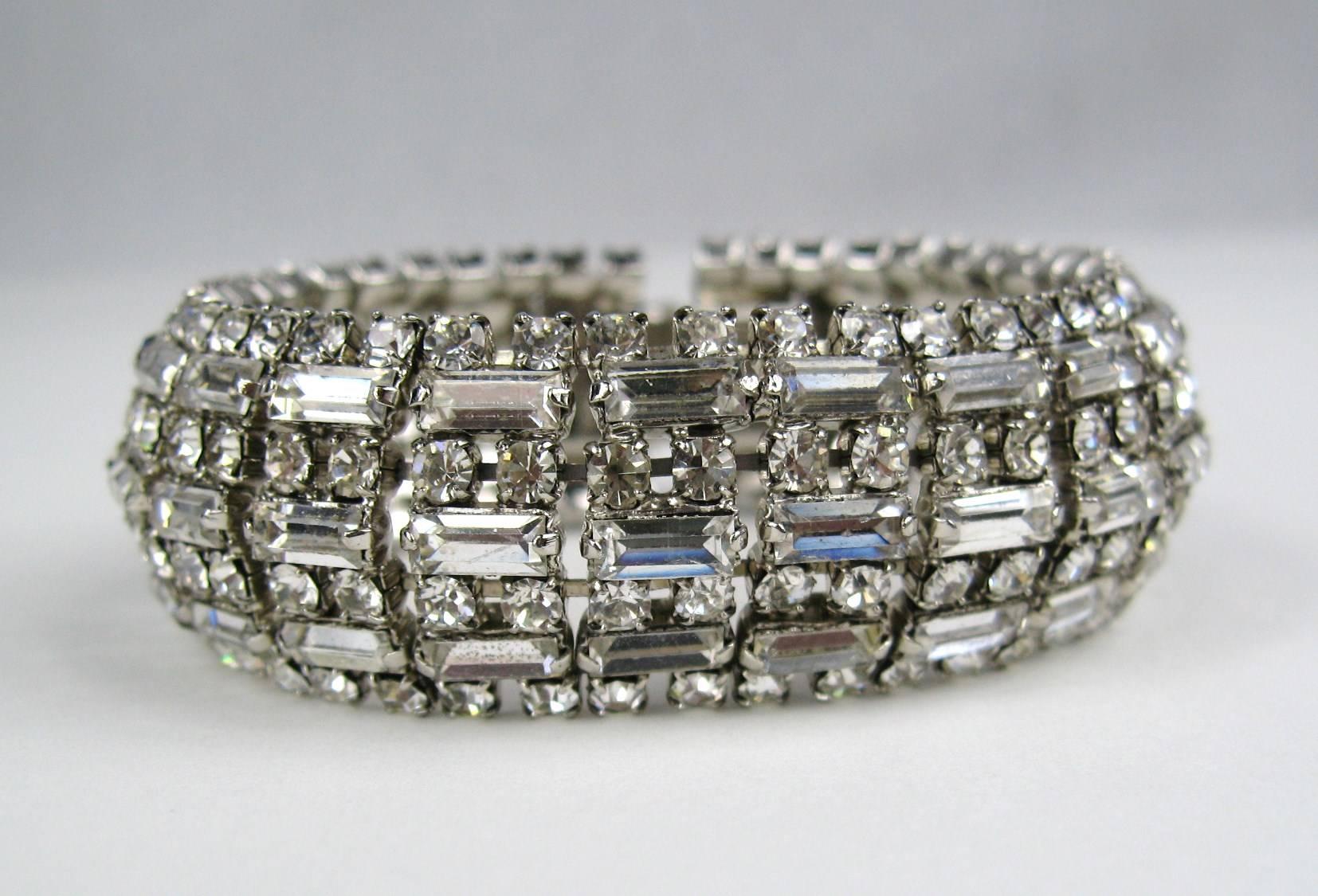 Stunning Wide Crystal Rhinestone Silver  Bracelet. Measuring .87 inches wide. Has a Slide-in clasp. 7.25 inches long to clasp. White Gilt Metal. This piece is unsigned, however, our client has attributed it Barrera. This is out of a massive