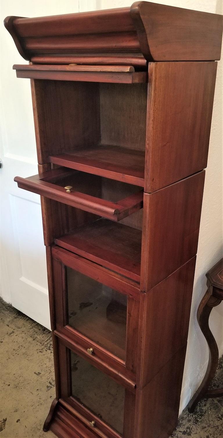 Presenting a barristers bookcase of neat proportions.

Made of teak and of lovely neat proportions.

Most barrister’s bookcase’s are much wider and taller, such as the Classic Globe Wiernicke examples. This one is much narrower and smaller and