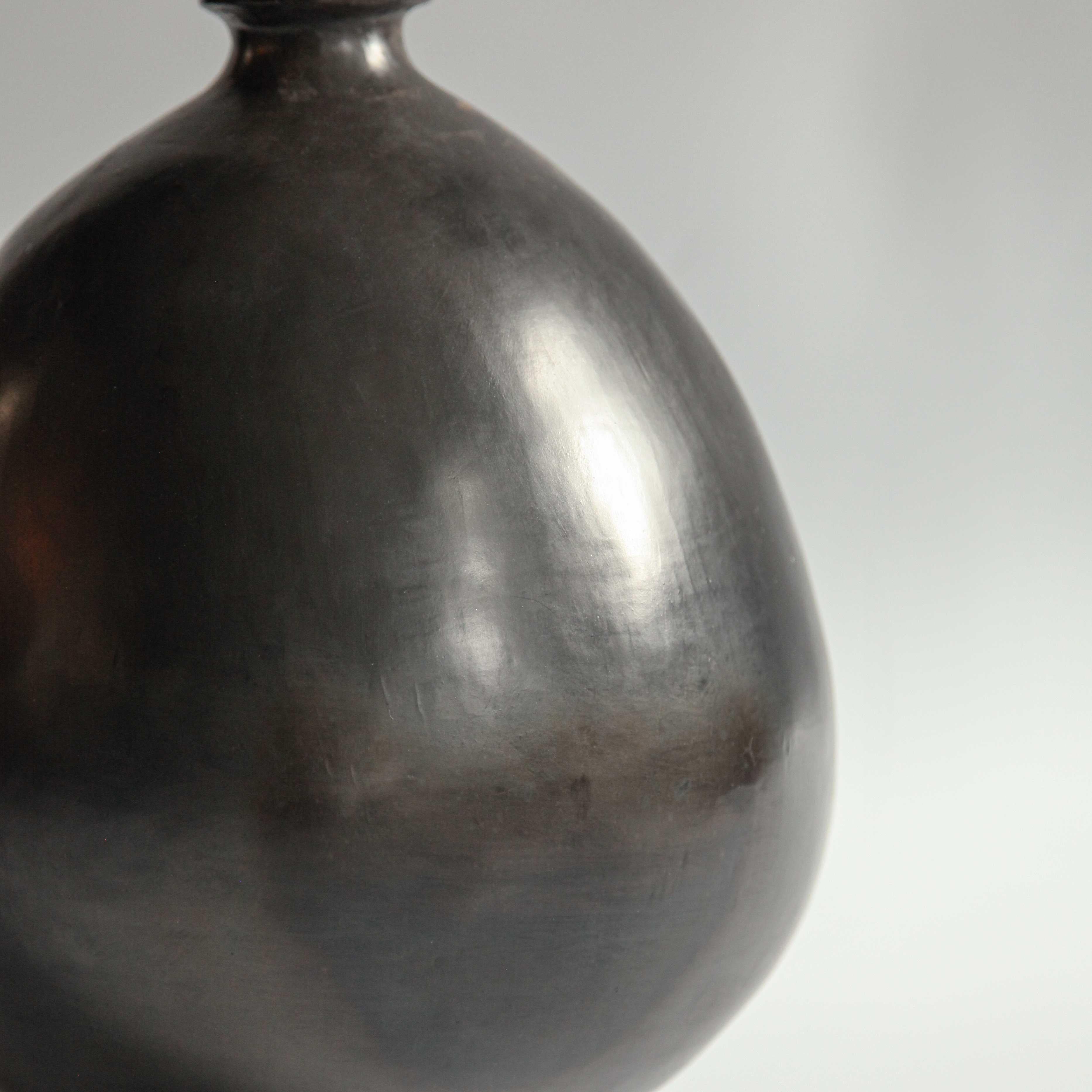 L'argile - connue sous le nom de barro negro - à partir de laquelle ces lampes de table sont fabriquées est exclusive aux montagnes de la Sierra Madre dans l'État mexicain d'Oaxaca. La légende locale veut que l'argile soit bénite.

La couleur