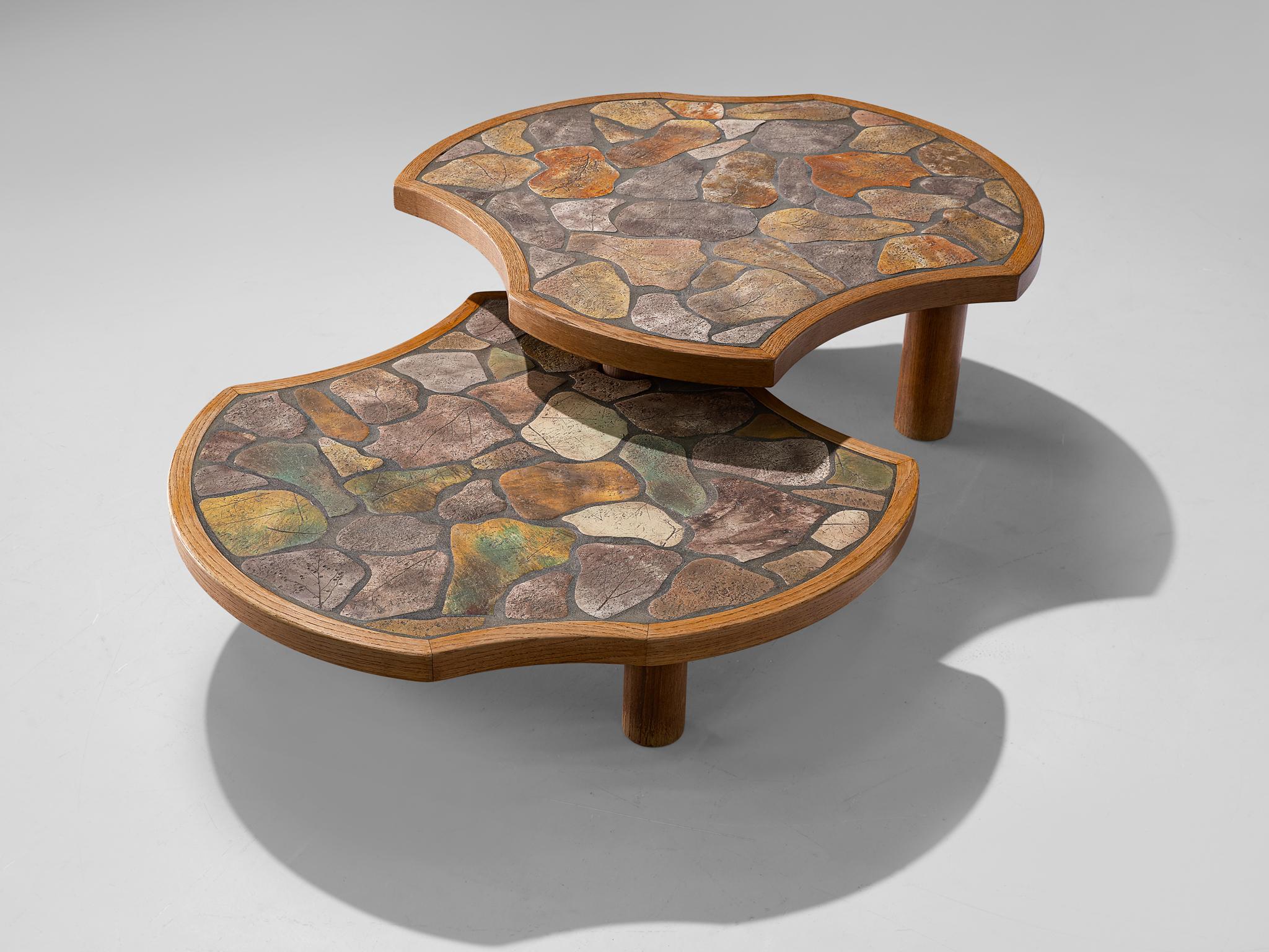 Barrois, coffee table, stone wear ceramic and oak, France, 1960s

Biomorphic shaped cocktail table, consisting of two tables connected to each other. One table is slightly higher than the other, which results in a dynamic look. Conical legs are