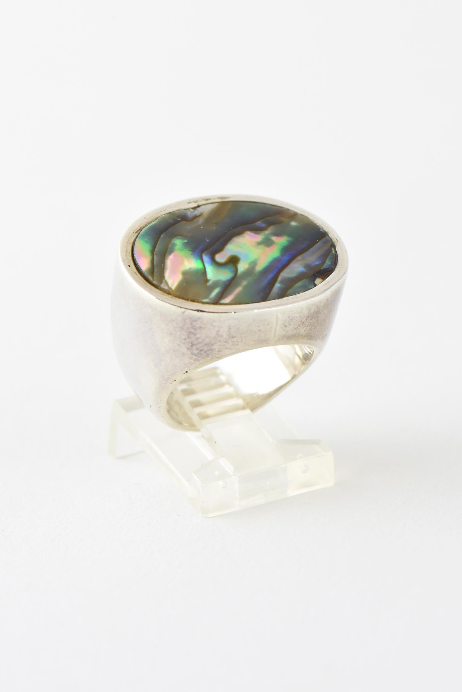 Handmade oval bezel-set abalone shell mounted in a sterling silver ring by Barry Brinker.

 U.S. size: 5.5. Marked 