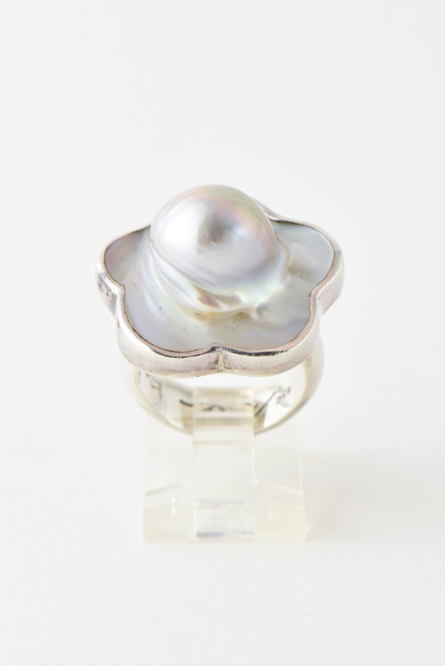 Handmade blister pearl flower mounted in a sterling silver ring by Barry Brinker. 

U.S. size: 5.25. Marked: 925.
