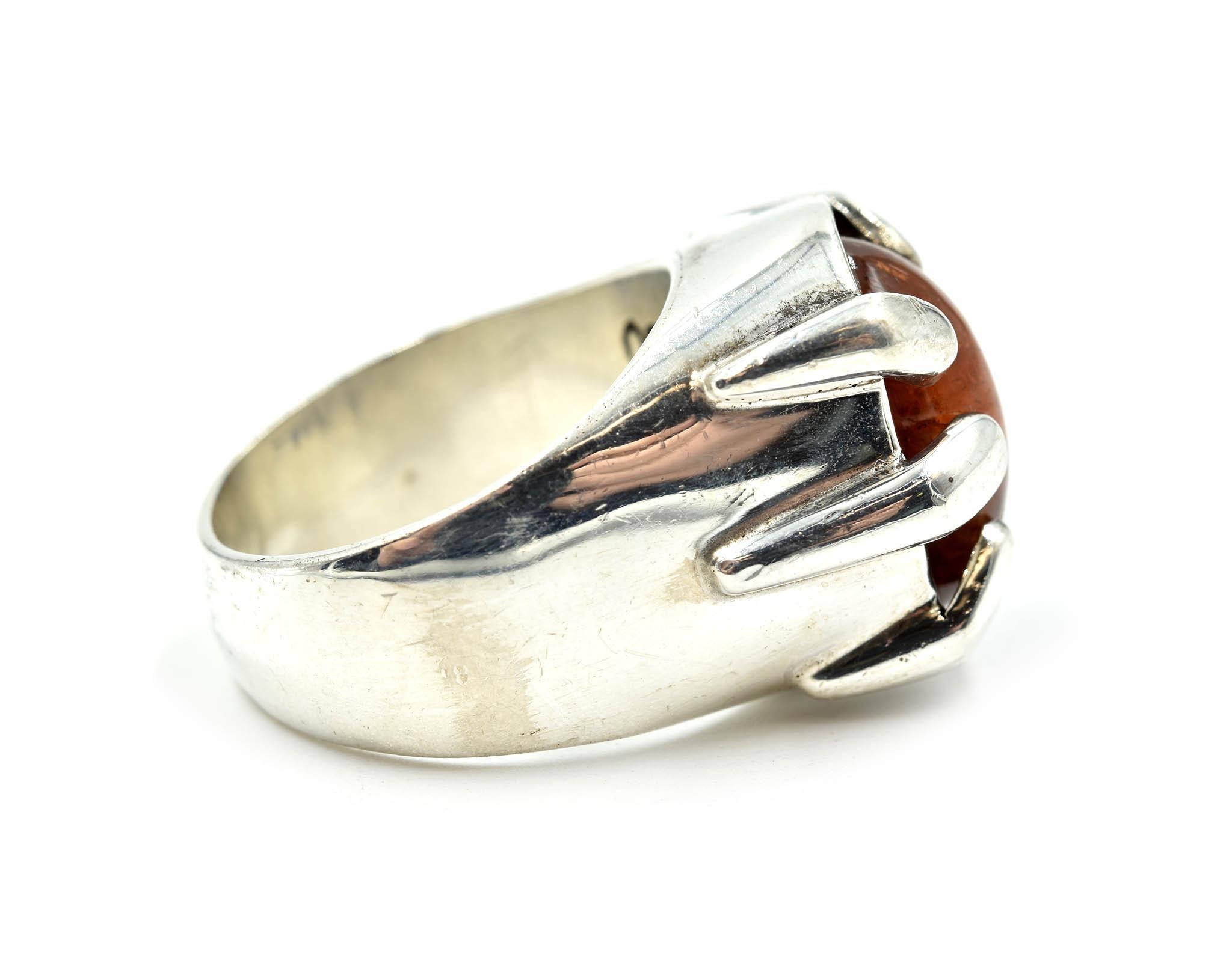 Designer: Barry Brinker
Material: sterling silver and hematite
Center Stone: round cabochon cut quartz
Dimensions: 18.43mm in length and 19.70mm in width
Ring Size: 9
Weight: 18.90 grams
