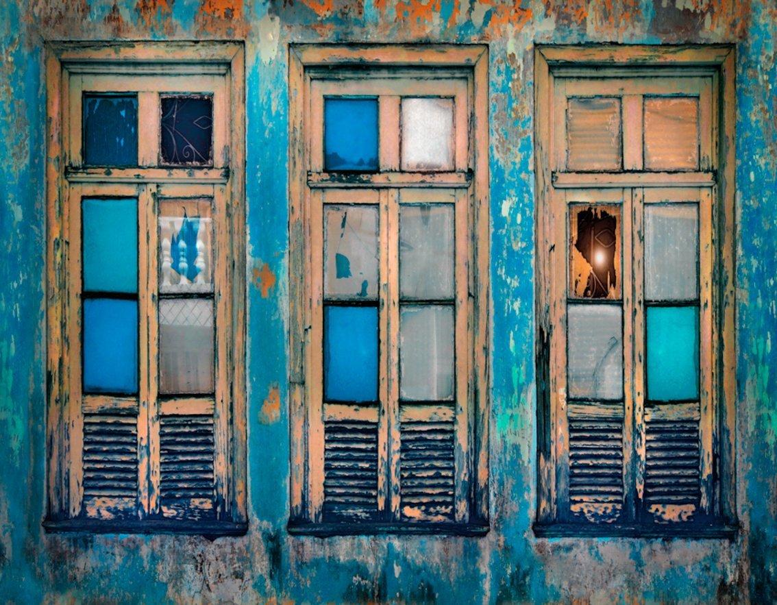 Painted windows in turquoise and yellow.
–
The Spaces in Between series developed out of visits to Naples in Italy and Havana in Cuba, two cities whose past glories are suffused with a faded grandeur.  Cawston’s search for these lost spaces of