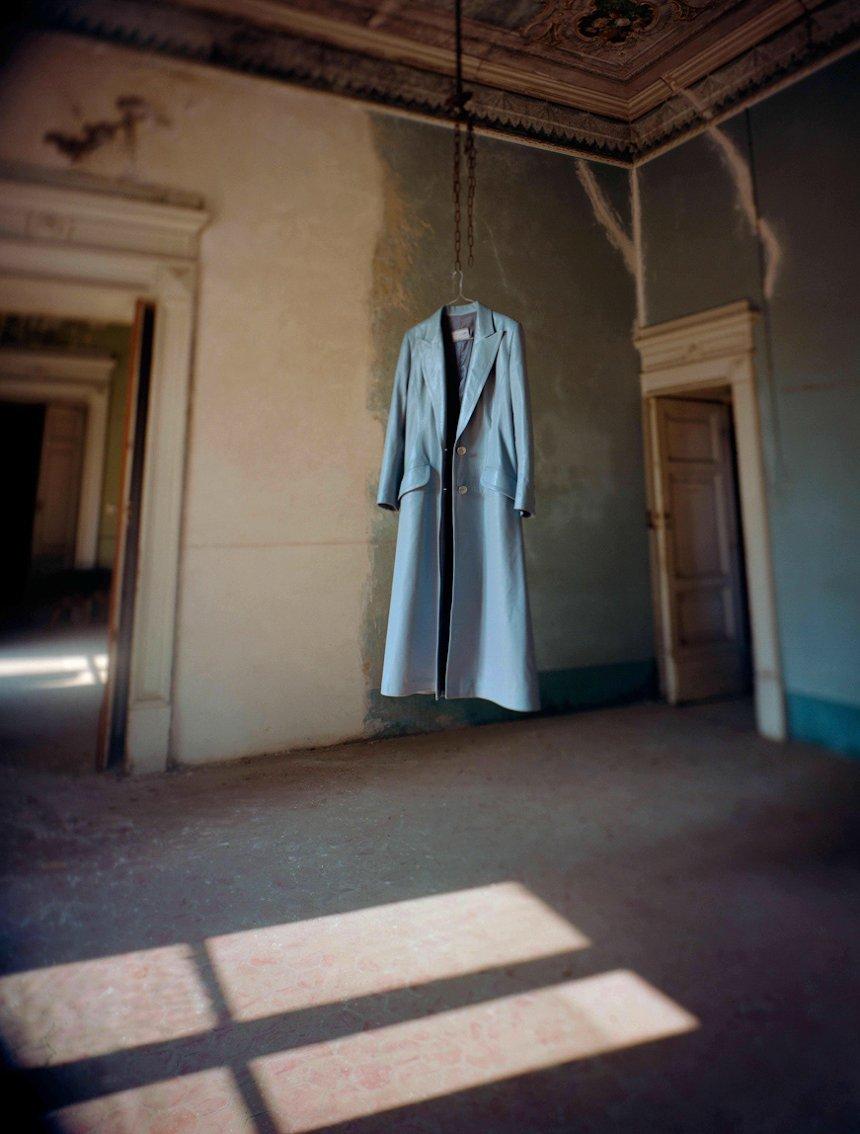 A coat of soft leather appears to float suspended in  an abandoned building in Naples.
–
The Spaces in Between series developed out of visits to Naples in Italy and Havana in Cuba, two cities whose past glories are suffused with a faded grandeur. 