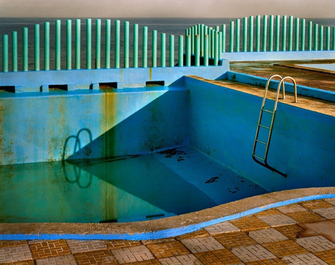An abandoned swimming pool in Havana.  Shot on colour negative with a large format camera.
–
The Spaces in Between series developed out of visits to Naples in Italy and Havana in Cuba, two cities whose past glories are suffused with a faded