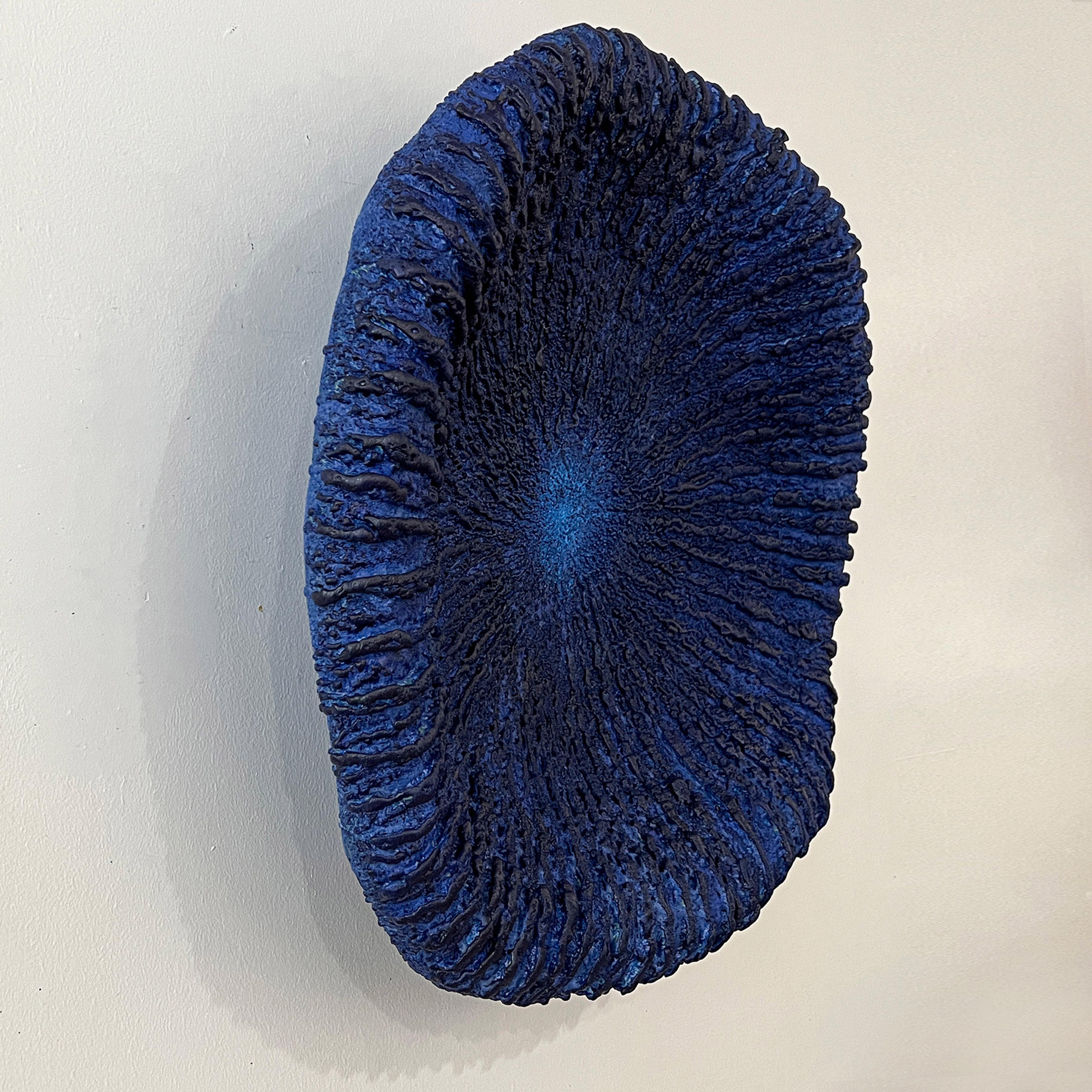 This minimalist blue 3D wall piece is by Barry Katz. He creates pieces that allude to the artist looking into a mirror. And in particular, one which reflects inner states. Not a mirror that flatters, far from, but one that tells inescapable truths.