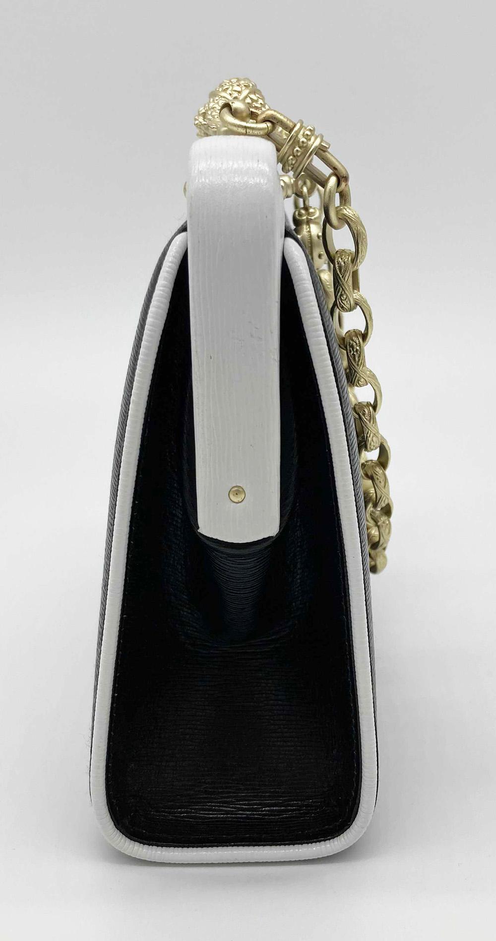 Barry Kieselstein Cord Black and White Frog Handbag in mint condition. Black sharkskin leather exterior trimmed with white leather piping and top edge. Matte gold signature style hardware featuring a top sliding frog latch closure with small ladybug