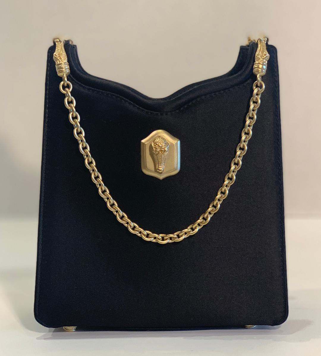 Very elegant designer Barry Kieselstein-Cord, black satin evening purse with the iconic gold tone Florentine finish metal alligator accents. This black satin evening bag has a gold alligator head on the front and four matte gold alligator heads