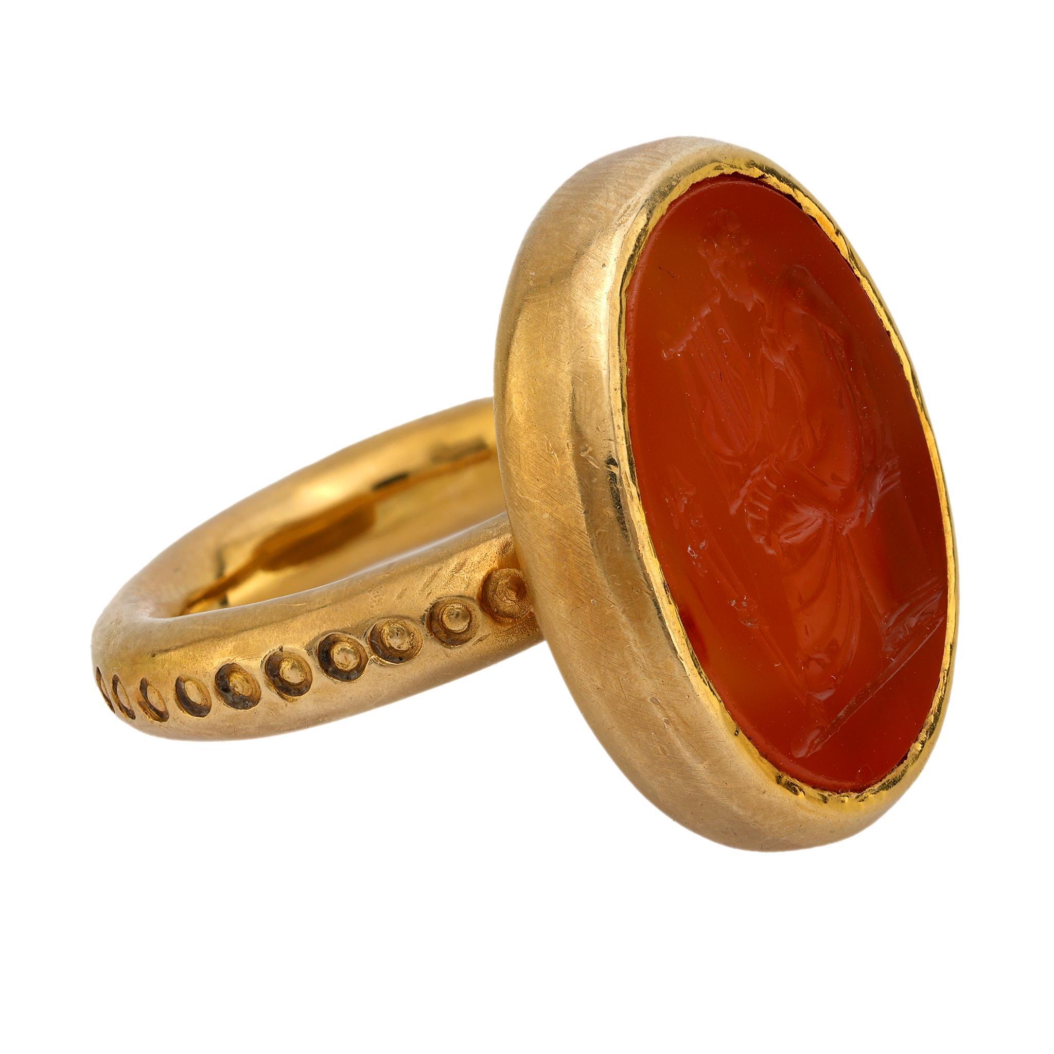 This ring features a carved carnelian stone set in 18k yellow gold. Hallmarked with purity and maker’s marks. Circa 1960s.

Center stone: Carved carnelian stone
Metal: 18k yellow gold 
Era: Vintage 
Circa: 1960's 
Hallmarks: Purity and makers marks