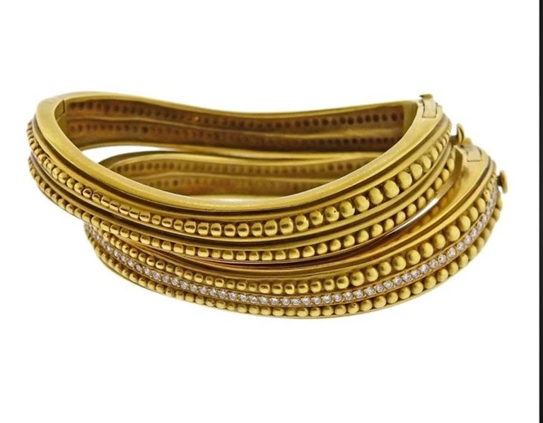 Stunning pair of Caviar bangles from the house of Kieselstein-Cord. These nesting 18K yellow gold bangles are each encrusted with Diamonds on one side. These bangles will be a classic staple in your wardrobe for day or night that you will never want