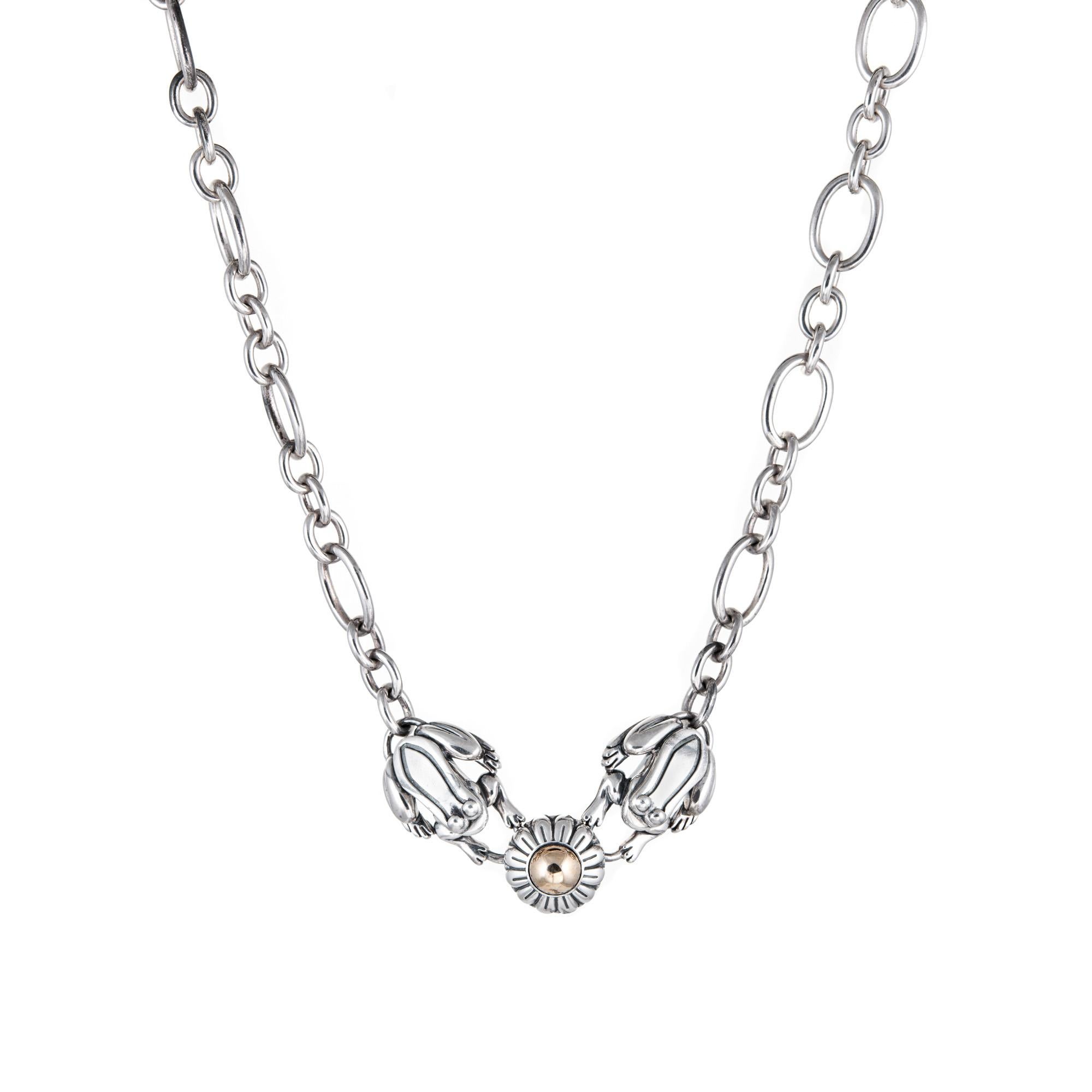 Stylish Barry Kieselstein Cord frog necklace crafted in sterling silver & 14 karat yellow gold (circa 1994).  

Two frogs frame a lily pad and make a great statement. Measuring 17 inches in length the necklace sits nicely just below the nape of the