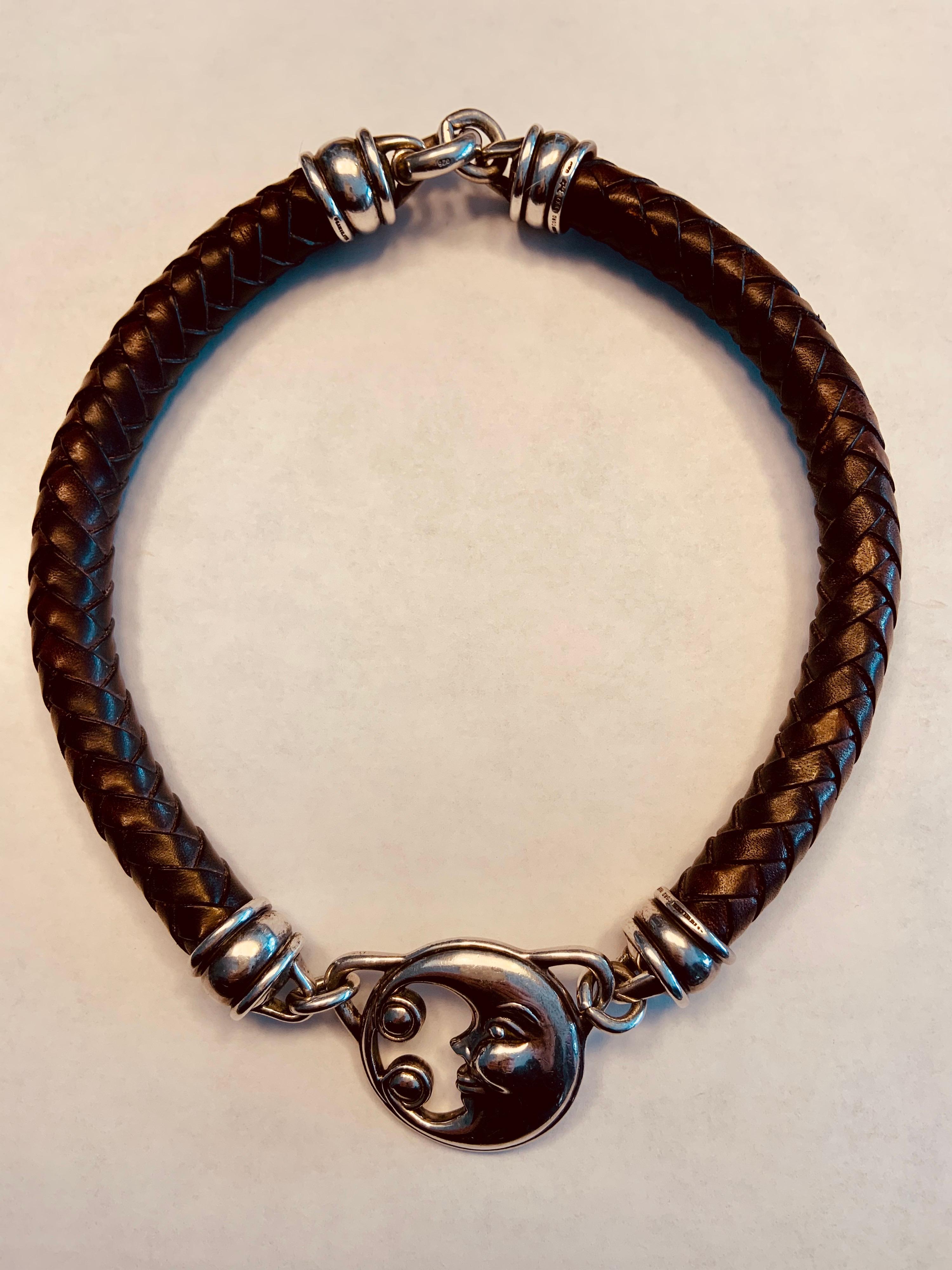 This Barry Kieselstein-Cord sterling silver and chocolate brown braided leather necklace has his iconic Man in the Moon at the center. The double sided Moon is stamped Kieselstein-Cord, 1998 and has the moon and star hallmarks.
Please see the last