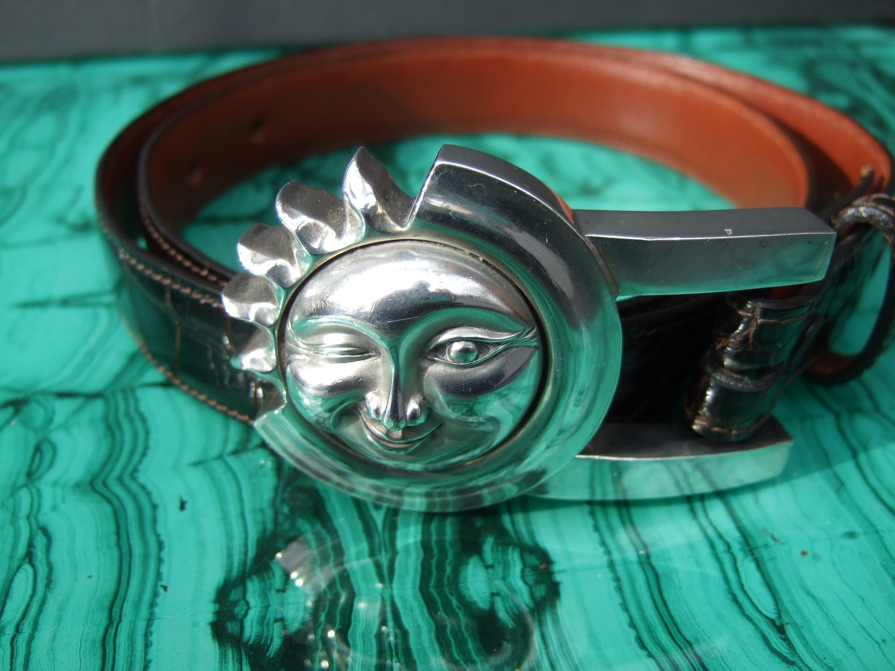 Barry Kieselstein-Cord Sterling silver moon & sun sleek brown alligator belt c 1990
The stylish belt is designed with a chunky large-scale sterling silver buckle
The celestial buckle depicts a moon-sun face buckle with a winking eye expression

The