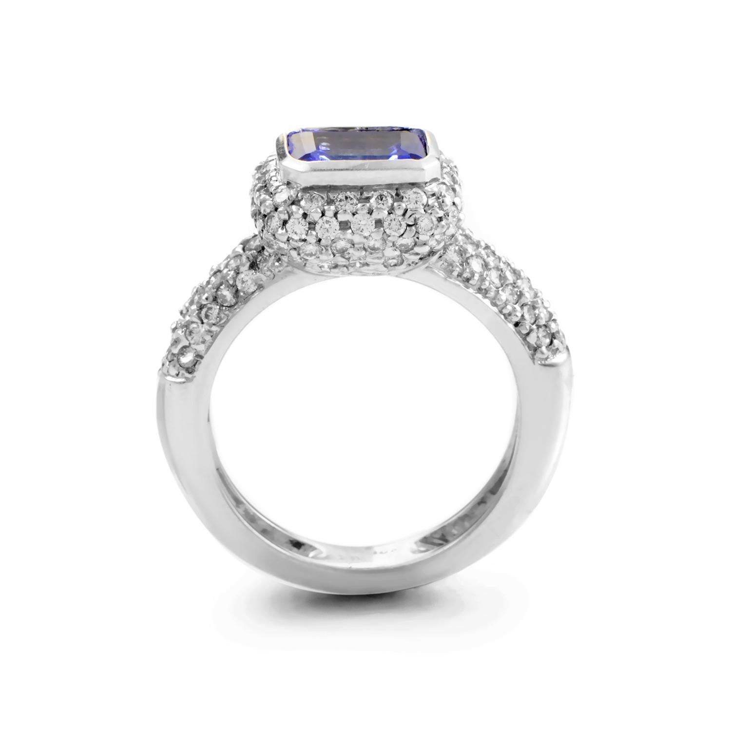 An exceptional design by Barry Kronen, this marvelous ring boasts the prestigious combination of elegant 18K white gold and magnificent blue tanzanite stone weighing 1.05 carats; the glamorous beauty of the ring is enhanced by the sparkle of