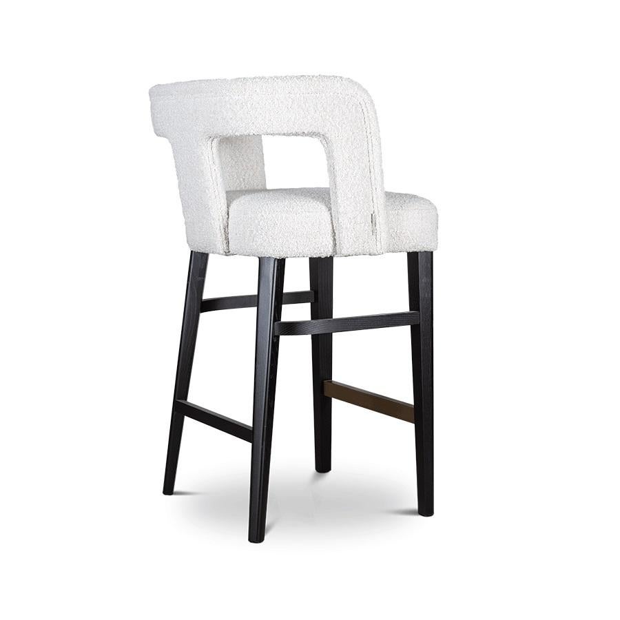 This barstool brings comfort as well as visual lightness with an open back.
This stool features a solid wood structure and legs in standard finishes.
Seat and back are constructed of molded plywood / MDF / hard pine with webbed seat suspension.