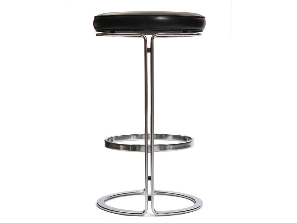 A pair of split beam steel bar stools with black leather seats.