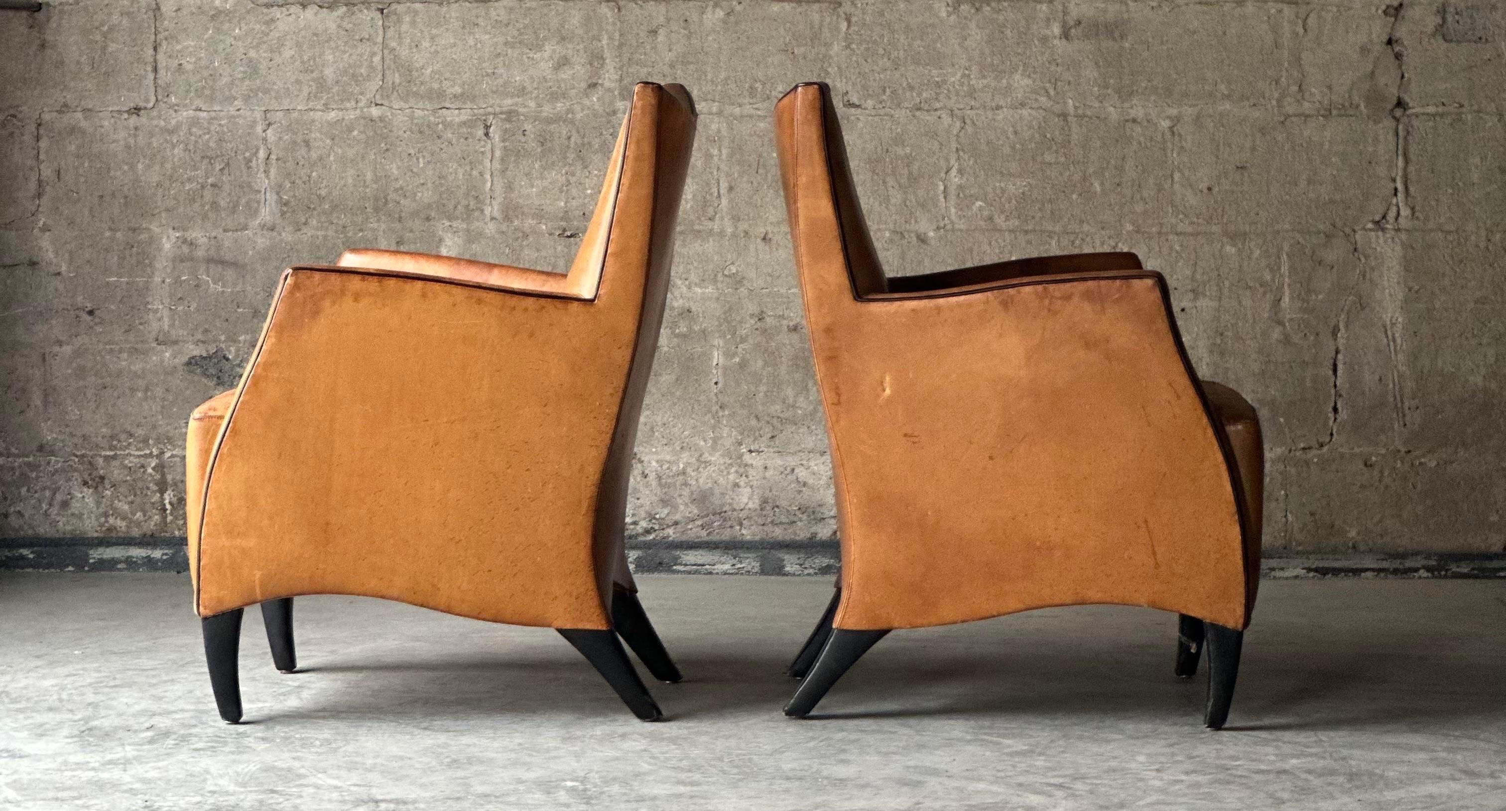 SO comfortable!! This angular pair of statement bergere armchairs by Bart Van Bekhoven for Artistiek are upholstered in brown sheep’s leather, with black leather covering shapely legs.