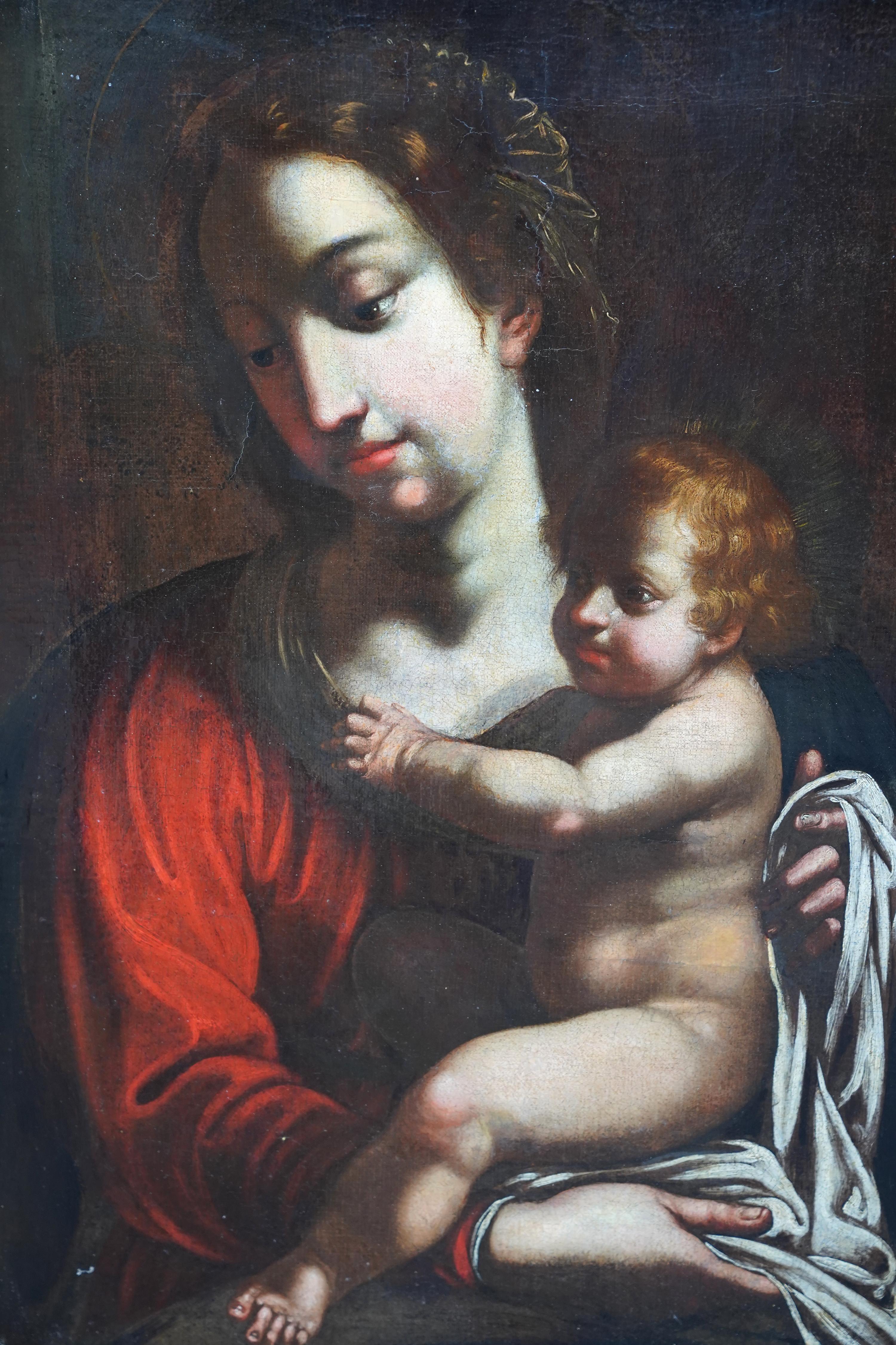 This superb Italian Old Master religious portrait oil painting is attributed to circle of Bartolomeo Schedoni.  Painted circa 1700 it is a half length portrait of the Madonna holding baby Jesus in her arms and dressed in a rich red robe. The detail