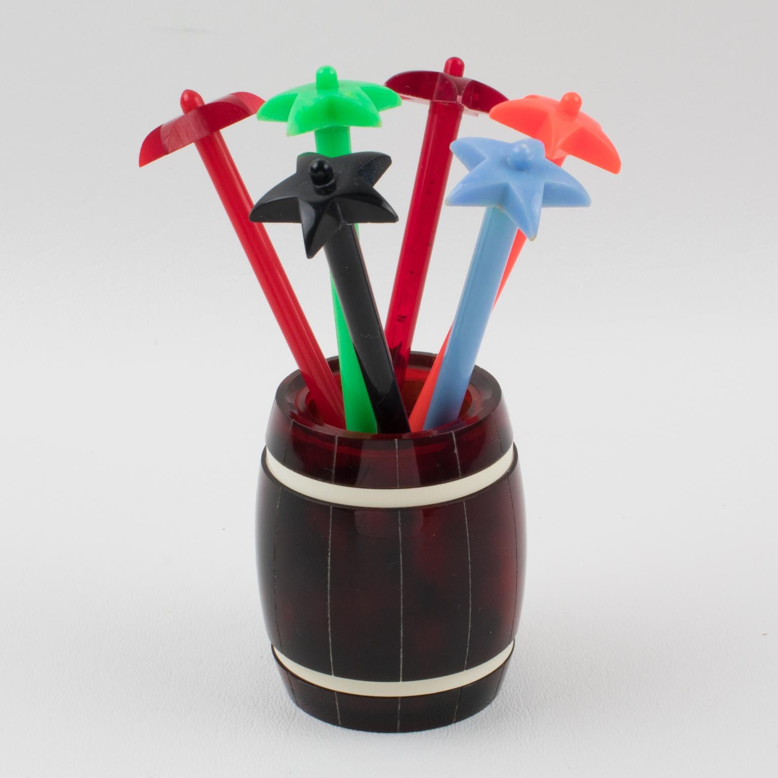 These lovely barware bar cocktail stirrers were made in France circa 1950. This Mid-Century bar tool is built with tortoiseshell (tortoise) marble Lucite featuring an oversized barrel holder with six long multicolor hard plastic stir sticks with a