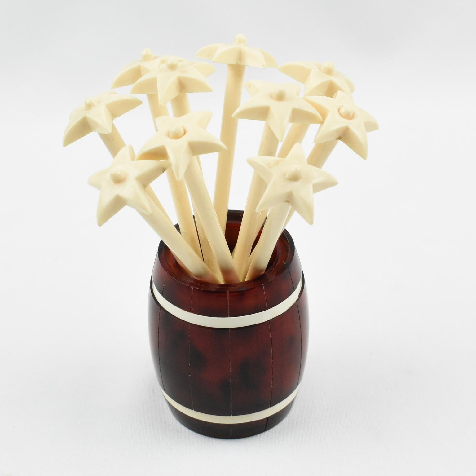 Lovely French barware bar set cocktail stirrers. This midcentury bar set is built with tortoiseshell (tortoise) marble Lucite featuring a huge barrel holder with ten long off-white plastic stir sticks with star finial. This set is very stylish, a