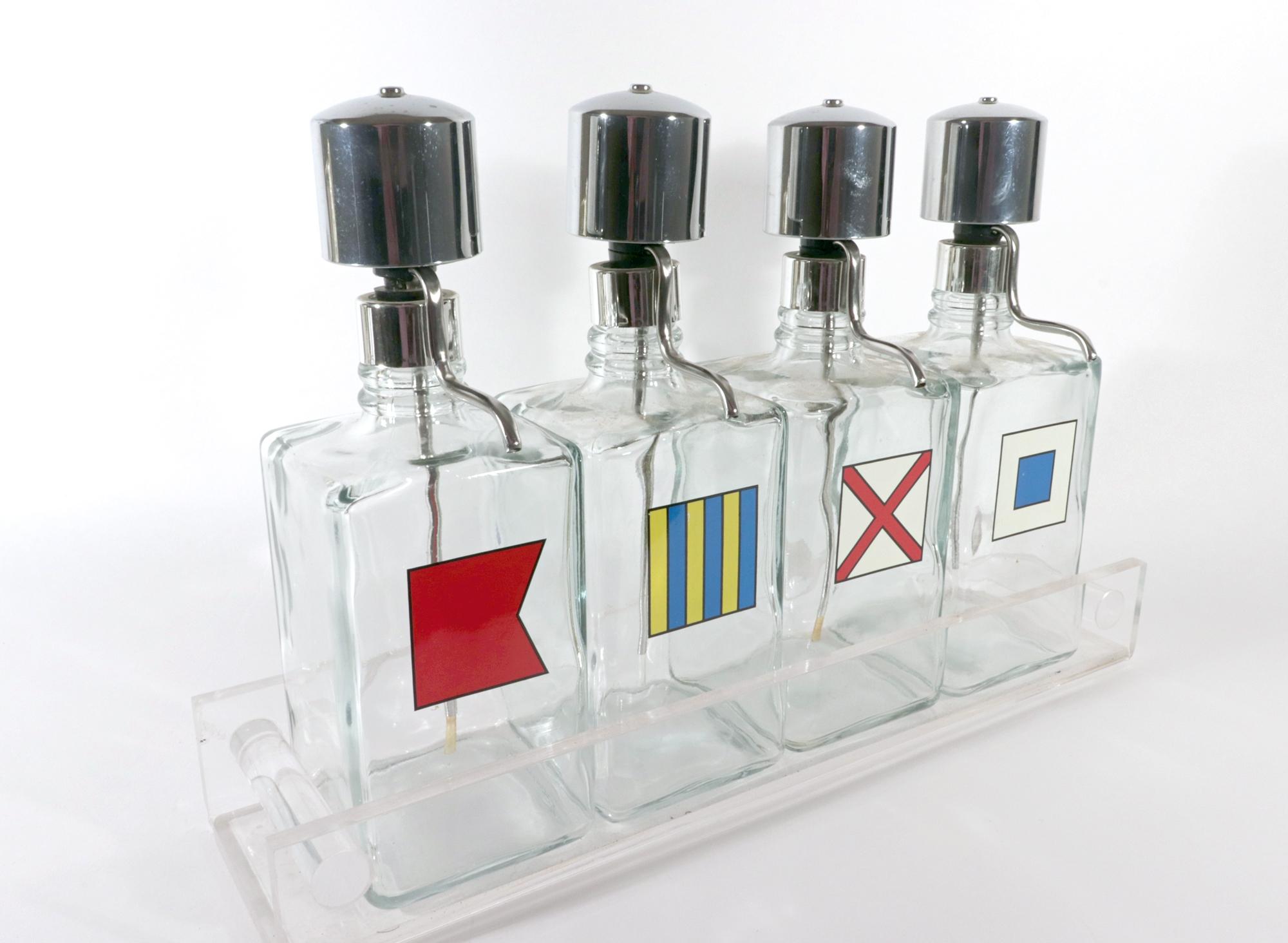 Barware Glass Liquor Dispenser Bottles on Lucite Base,
Mid-Century Modern,
Set of Four,
Circa 1970

The charming MCM maritime-influenced vintage barware liquor dispenser set consists of four square glass dispensers with a chrome dispenser pump and