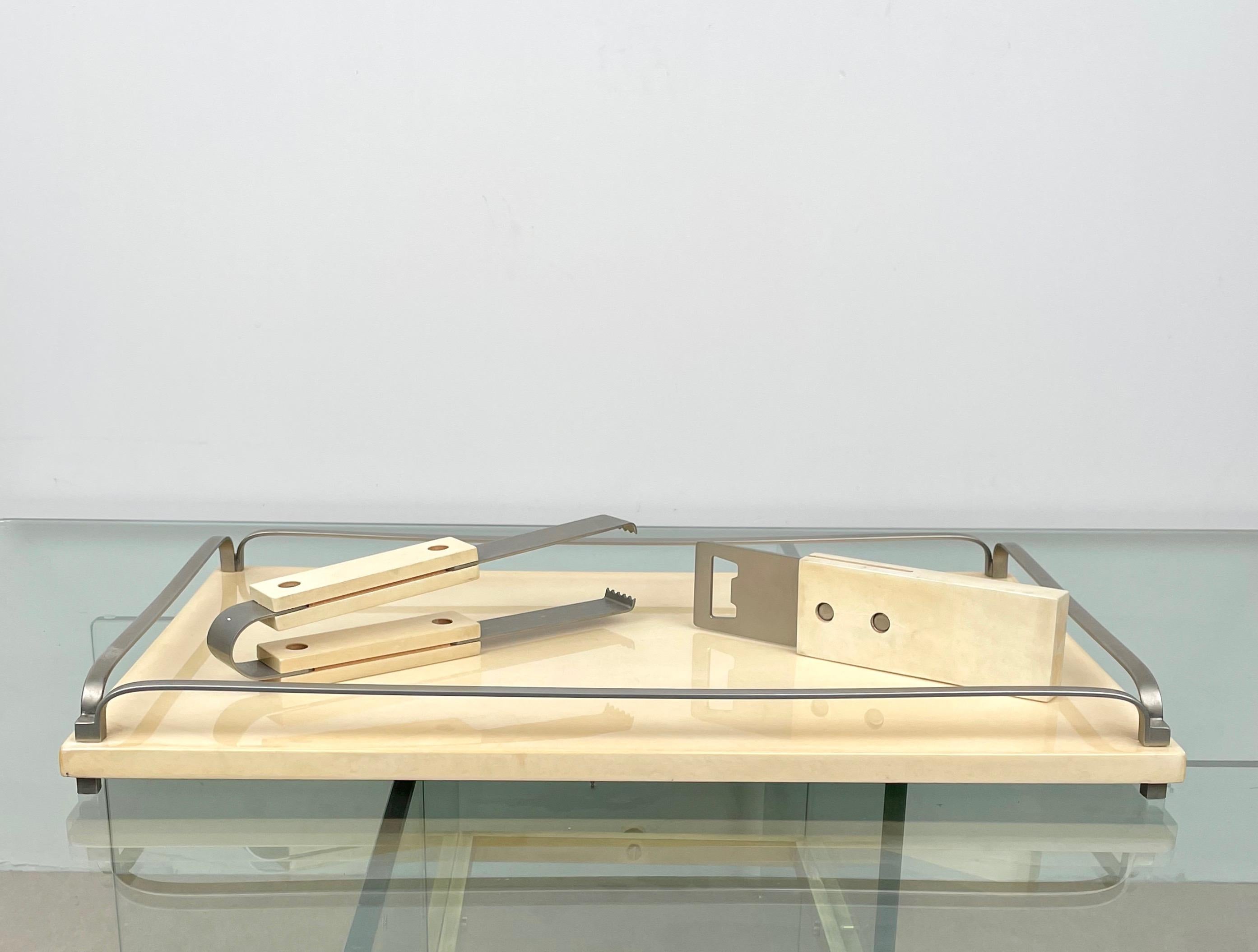 Barware set composed of a serving tray, tongs and corkscrew in white goatskin and steel details by the Italian designer Aldo Tura. Made in Italy in the 1950s.

The original label is still attached, as shown in the pictures.