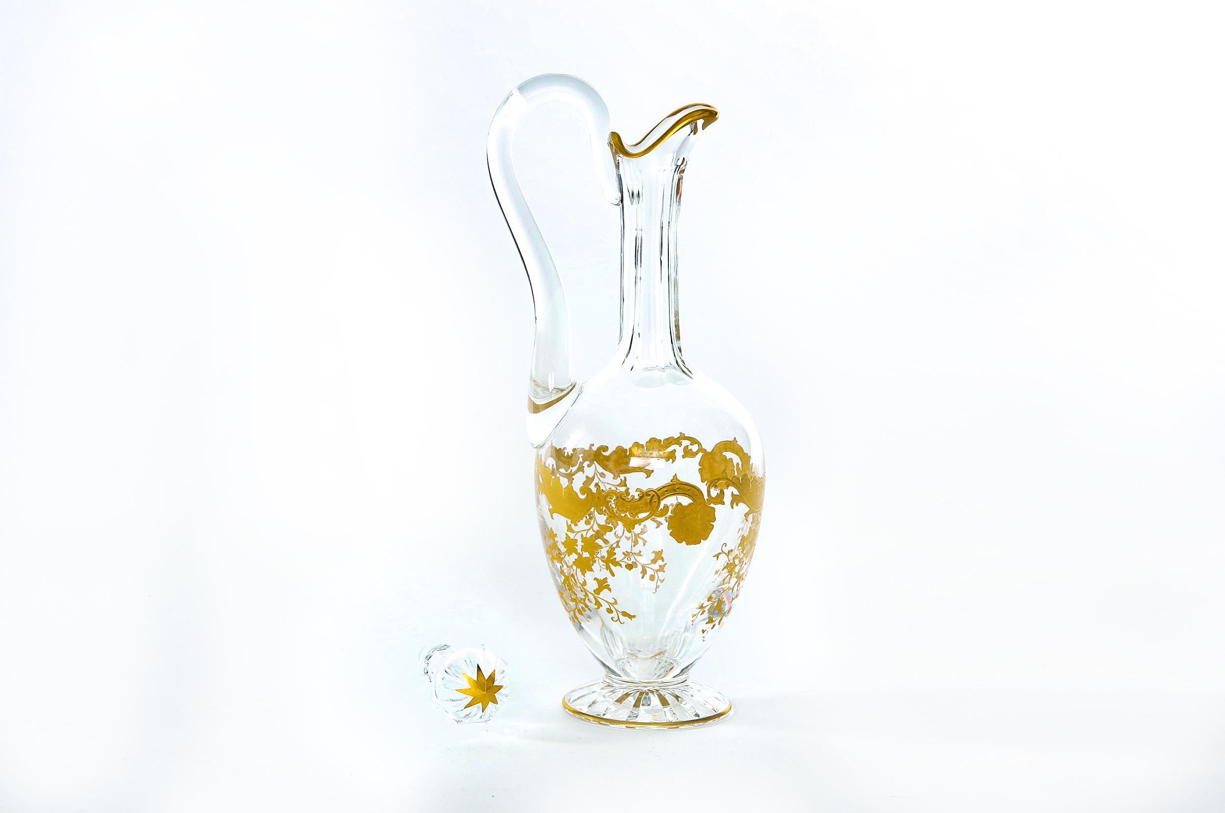 Mid-20th century Saint Louis crystal with gold design details tableware or barware decanter. The decanter is in great condition. Maker's mark stamped undersigned. It stands about 15 inches tall x 5 inches diameter.
