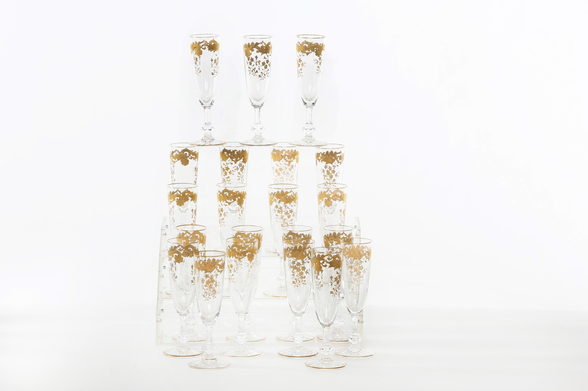 Mid-20th century Saint Louis crystal with gold design details tableware / barware champagne flute service for twenty people. Each one is in great condition. Maker's mark stamped undersigned. Each one stands about 7 inches tall x 2.5 inches diameter.
