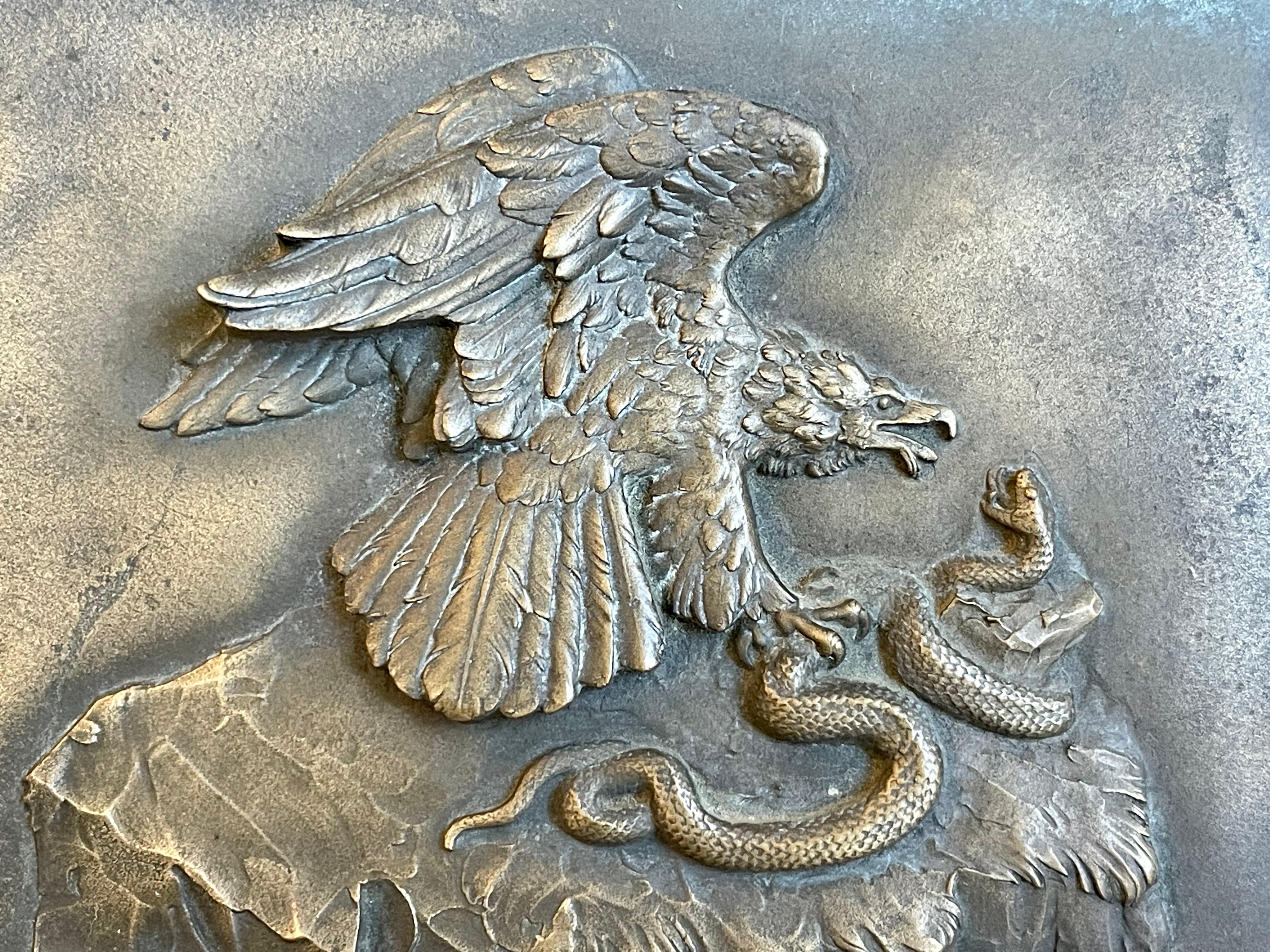 Bronze bas relief representing a golden eagle attacking a snake. Signed on the Rock 