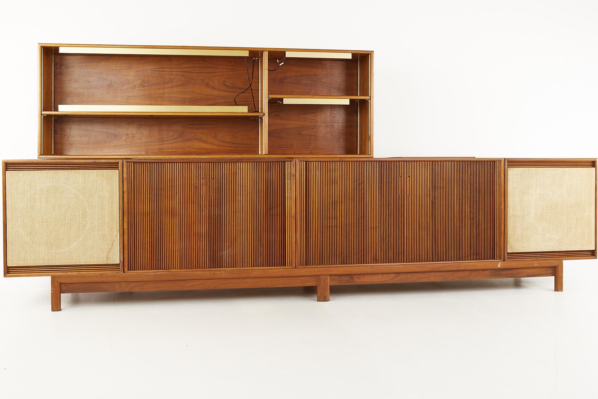 Barzilay mid century modular tambour door stereo console and bar

The console measures: 131 wide x 18 deep x 55 inches high

All pieces of furniture can be had in what we call restored vintage condition. That means the piece is restored upon