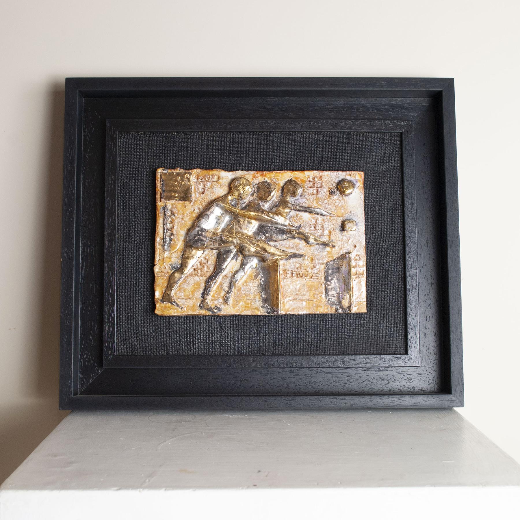 Ceramic plaque bas-relief depicting athletes.