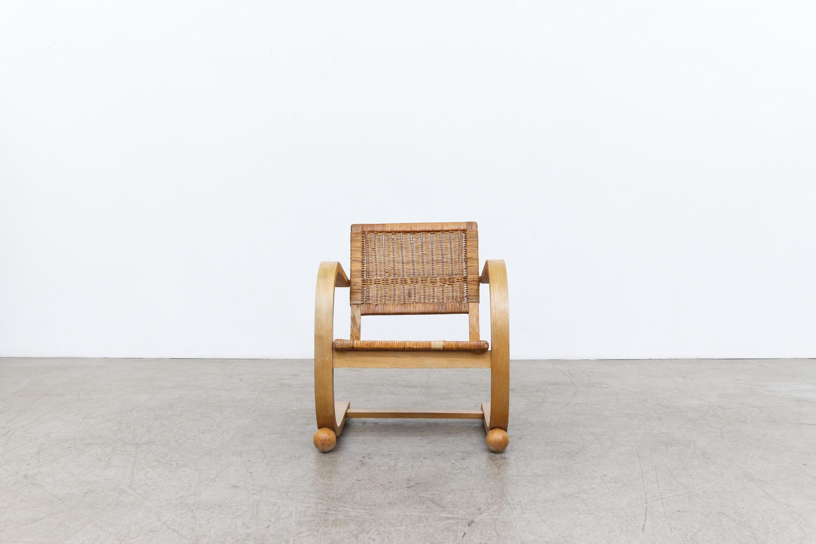 Bas van Pelt (attr) Bent wood lounge chair with rattan seat and ball feet. Refinished frame with original rattan seating. Seating shows visible wear and heavy patina with some repaired breakage to rattan. Wear is consistent with its age and use.