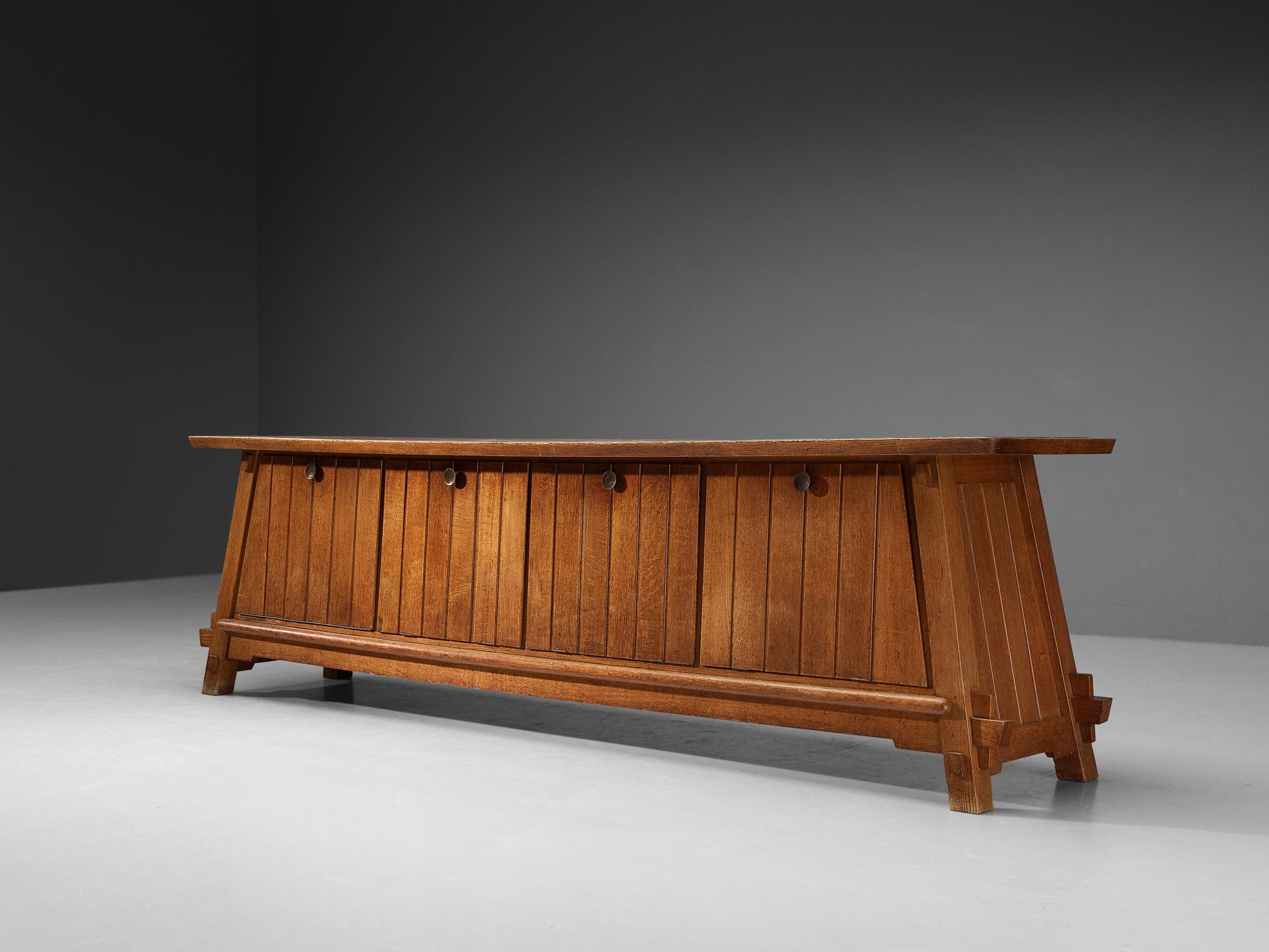 Bas van Pelt, sideboard, oak, brass, terracotta, The Netherlands, 1940s

This grand sideboard by Dutch designer Bas van Pelt is exemplary for refined, highly detailed and very well-made furniture. The corpus is based on a trapezoid shape which is