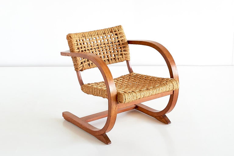This rare armchair was designed by Bas Van Pelt and produced in the Netherlands, circa 1936. The striking curved frame is made of oak, the seat and backrest retain their original and very well preserved braided rope. The chair is surprisingly