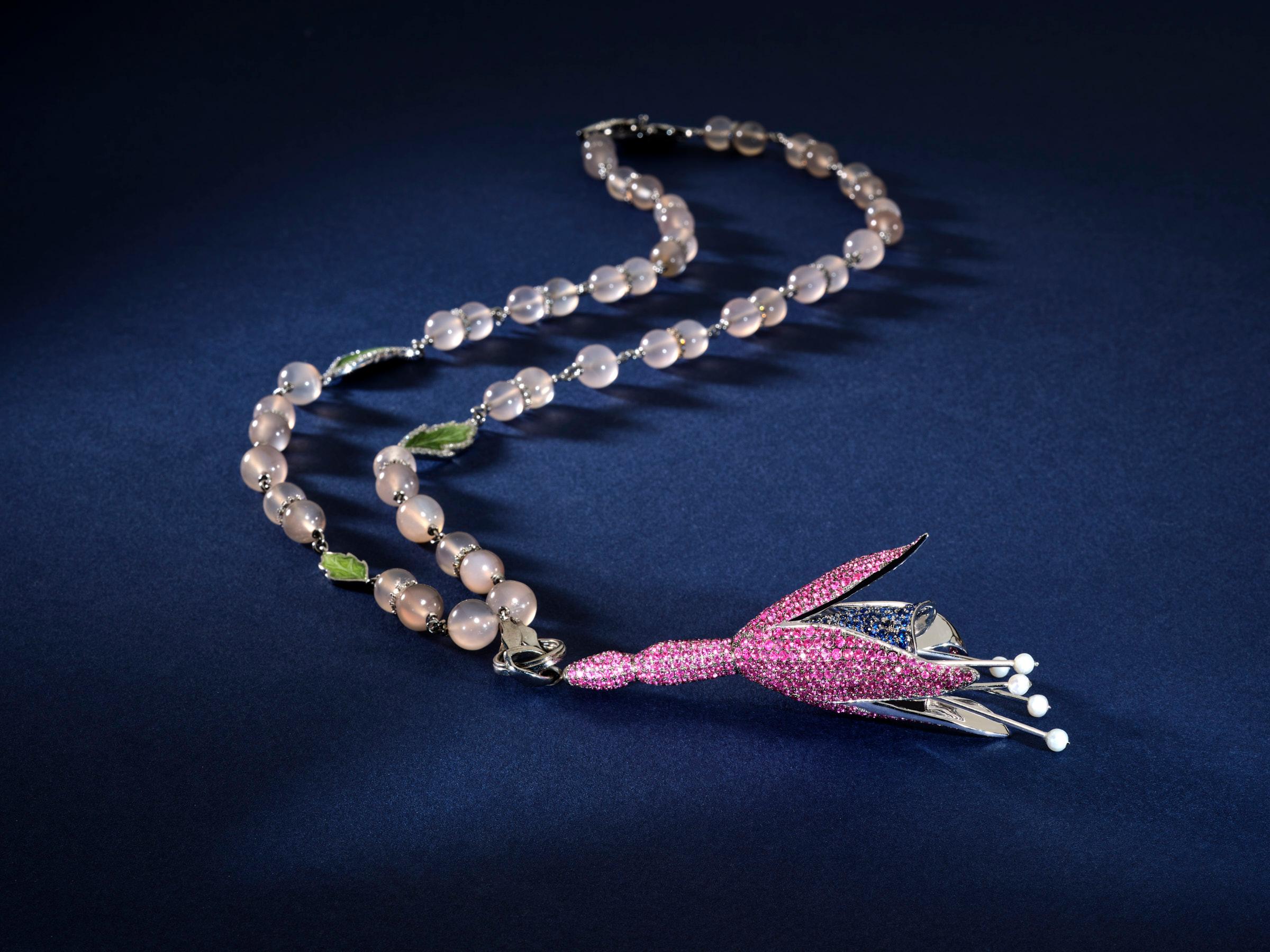 This necklace is true masterpiece, and one and only sample hand made by artisans in Grand Bazaar. It's production took more than 3 months, with more than 2000 stones set on the pendant. 
it is made of 18k white gold, diamonds (4 ct) blue and pink