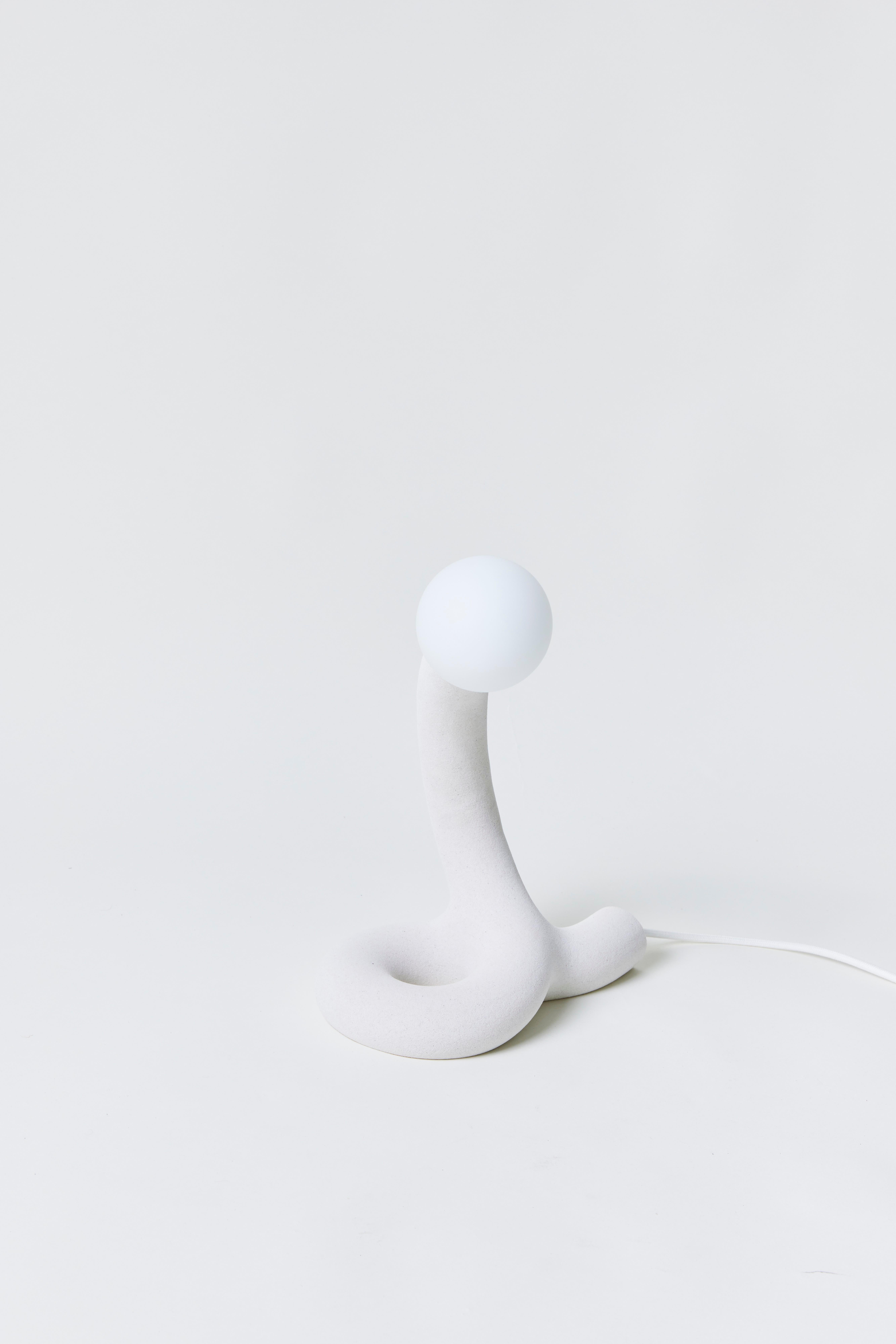 Basic Knot Variations 6 Desk Light by Hot Wire Extensions
Dimensions: D 25 x W 18 x H 36 cm 
Materials: Waste nylon powder, natural white marble sand, copper pipe, hand-blown glass bulbs, natural cotton electrical cord.
2 kg

Different sands and