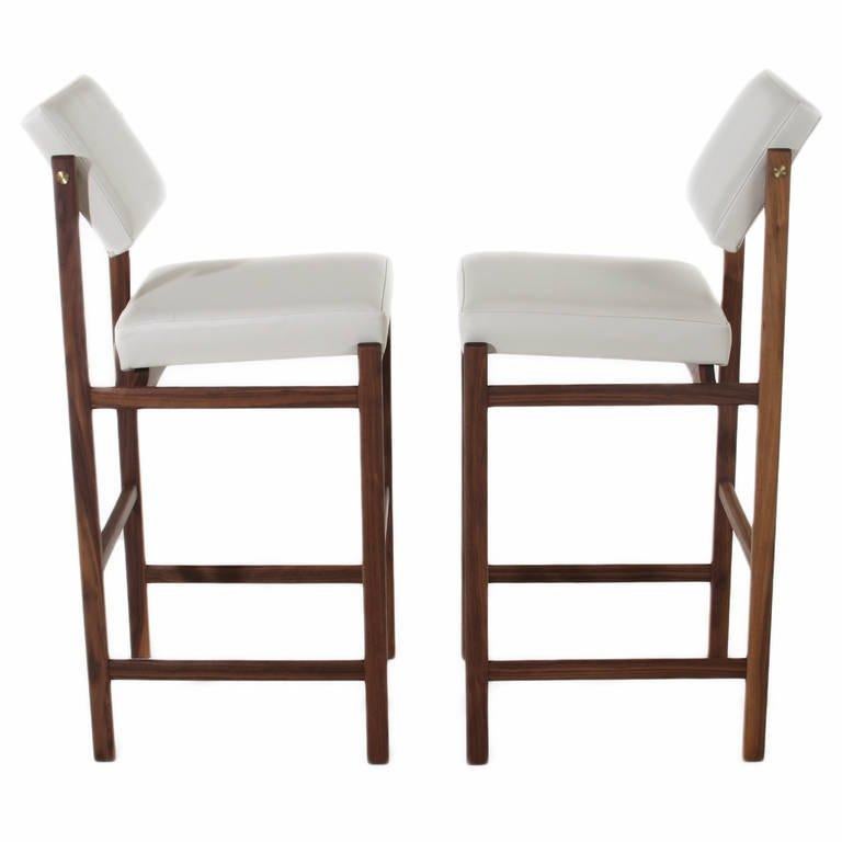 An elegant, solid wood stool available in walnut or oak with a variety of finishes, pivoting back (can be fixed upon request), and upholstered seat by Thomas Hayes Studio. The adjustable back provides lumbar support, and the frames are accented with