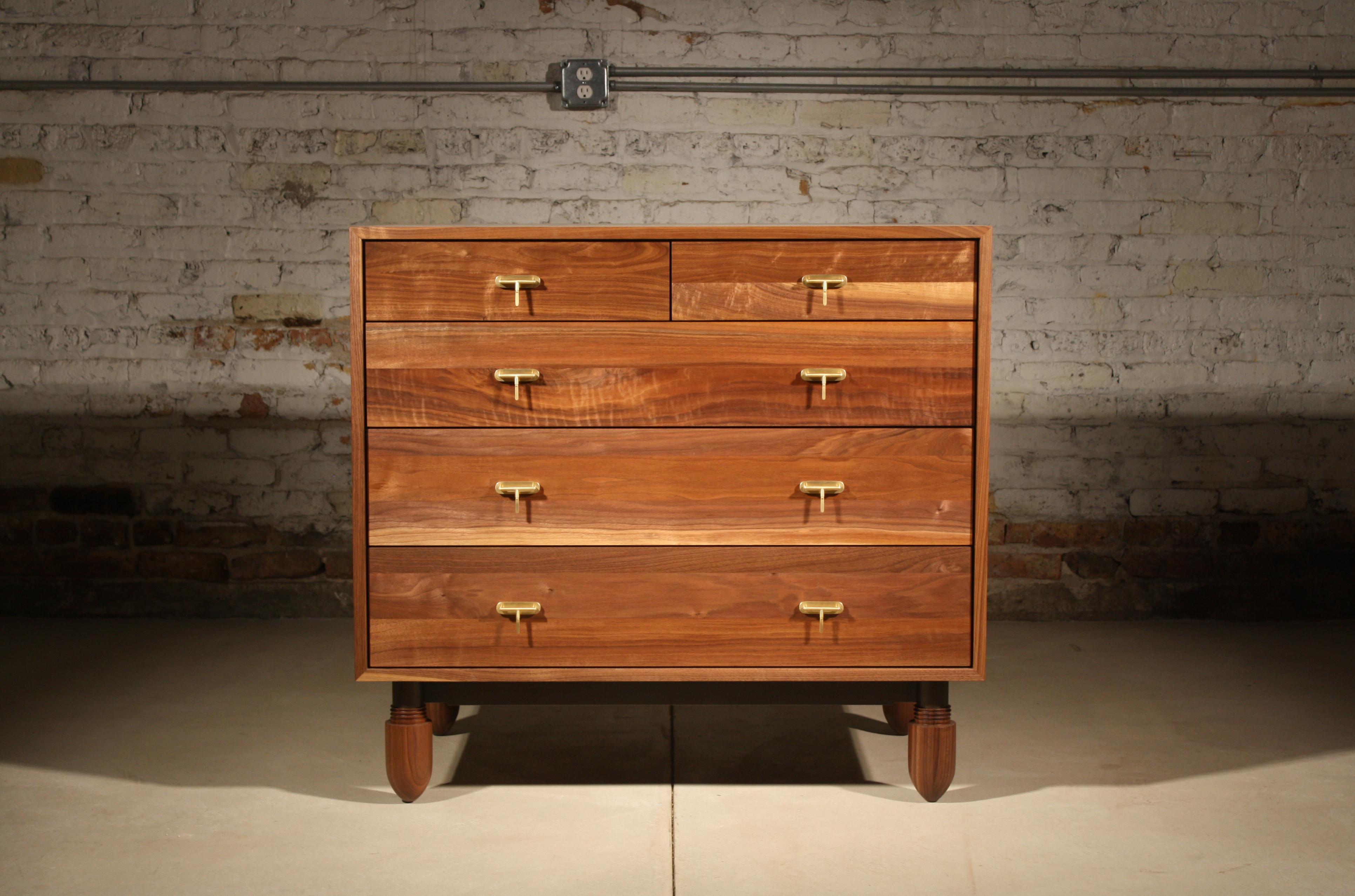 Natural walnut, blackened steel, satin brass, and merino wool felt.

5 Drawers - 40” wide x 36” tall x 24” deep.

Custom dresser built in celebration of both craft and detail. The hand-finished, mitered wood cabinet is filled with felt-lined,
