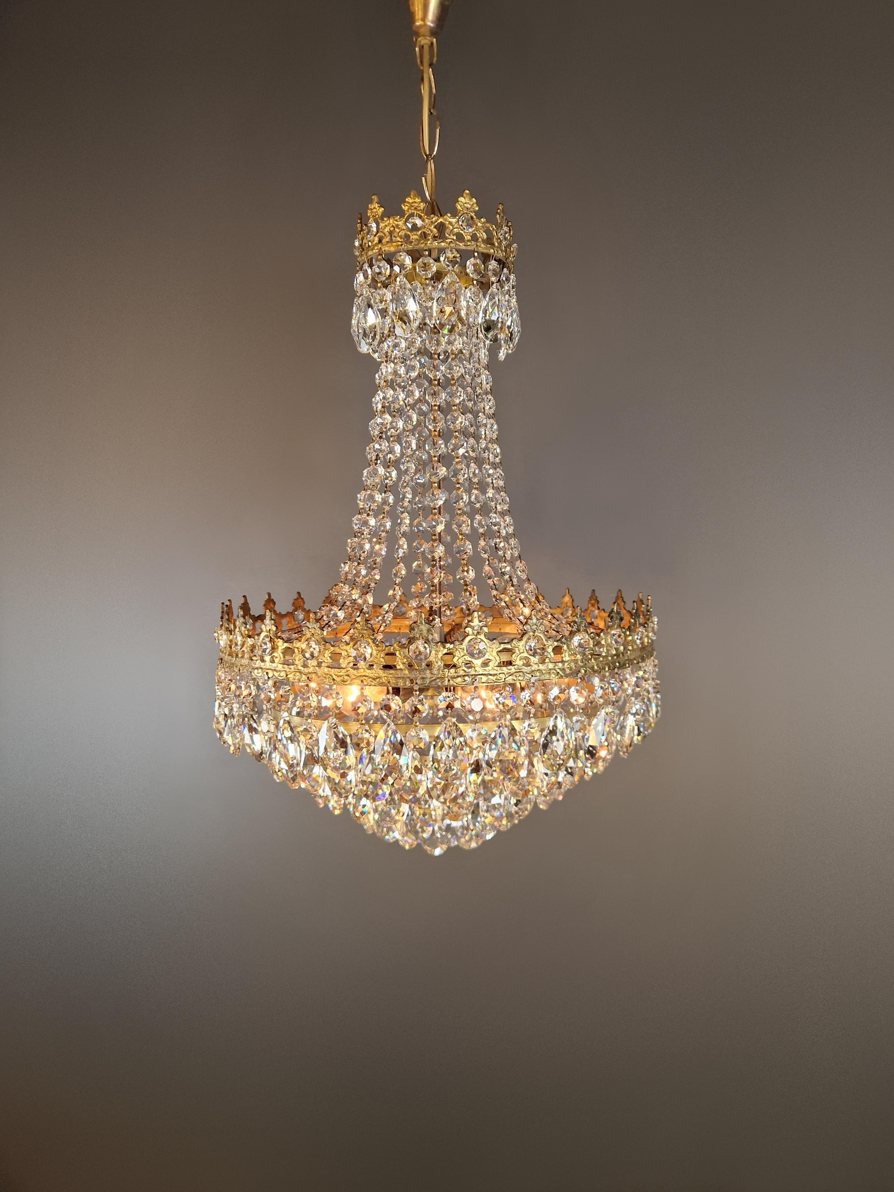 Introducing our beautifully restored old chandelier from Berlin! This exquisite piece has been professionally refurbished with love, making it suitable for use in the US with its rewired electrical system. Not a single crystal is missing, and each