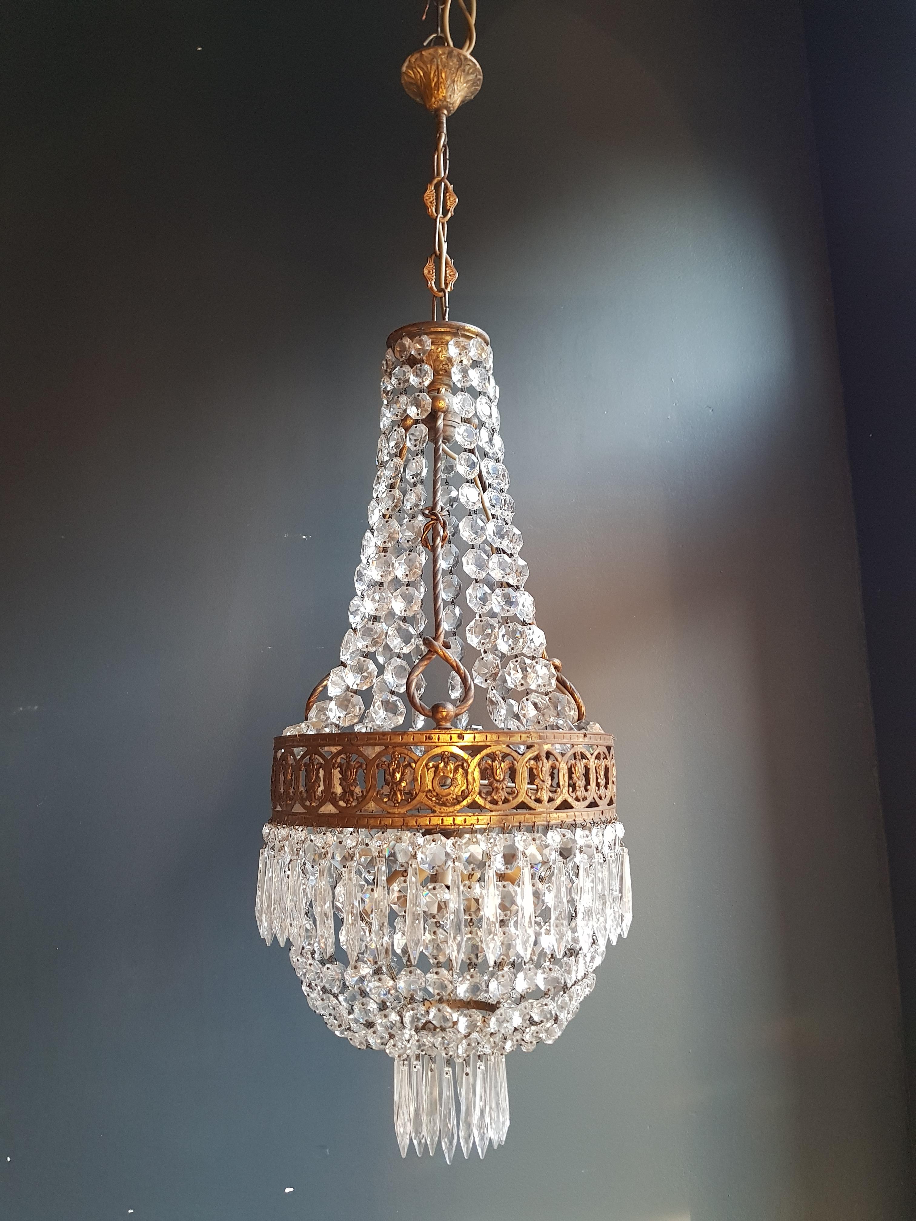 Presenting an exquisite brass Empire crystal lustre ceiling lamp, an antique Art Nouveau treasure in the form of a basket chandelier.

This chandelier, dating back to circa 1930, is an original preserved piece with its timeless beauty intact. It has