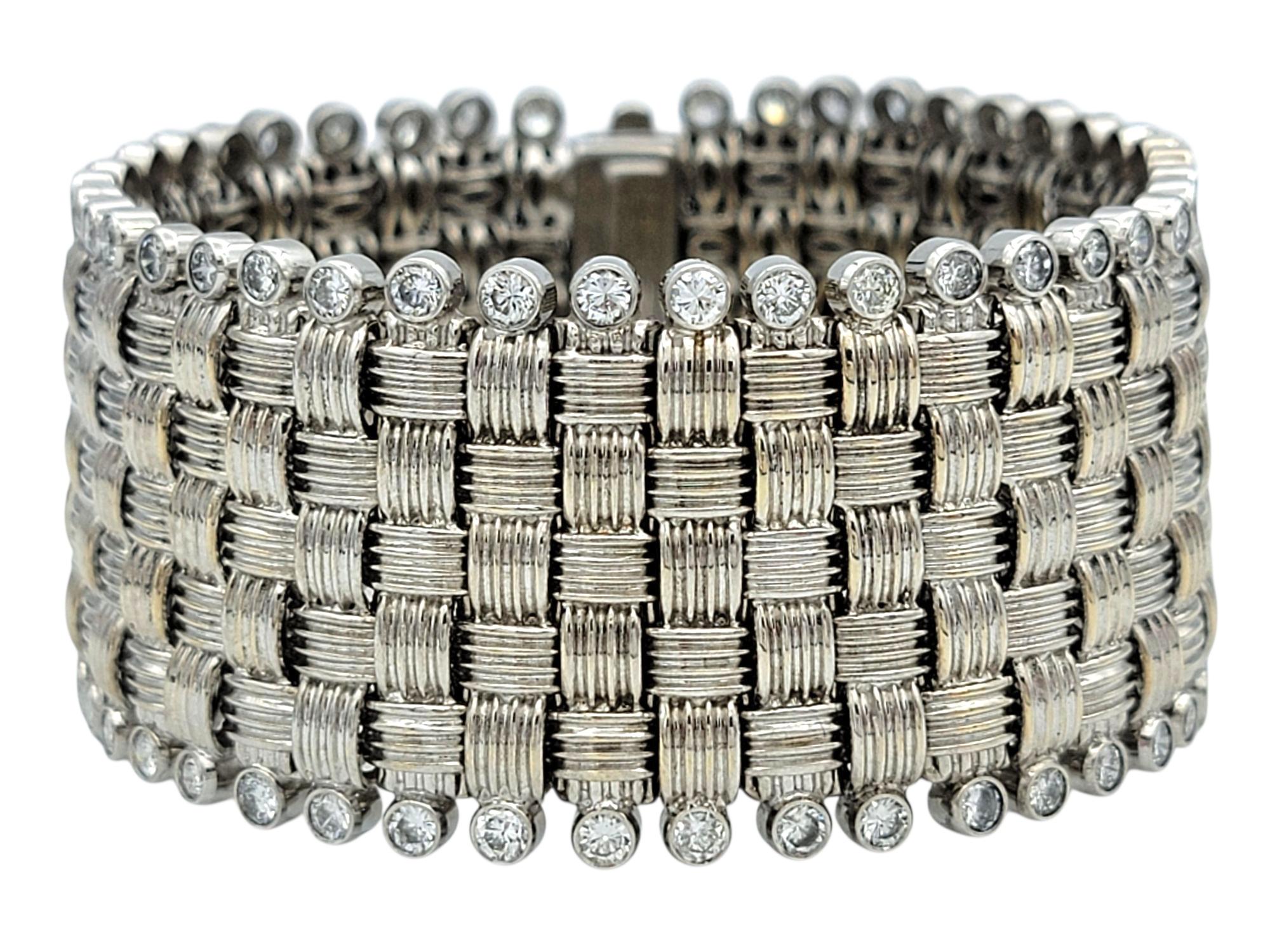 This diamond woven bangle bracelet offers a masterful mix of metals and textures, blending the cool tone of 18 karat white gold with the shimmer of natural diamonds. The extra wide bracelet features a tightly woven design that feels both intricate