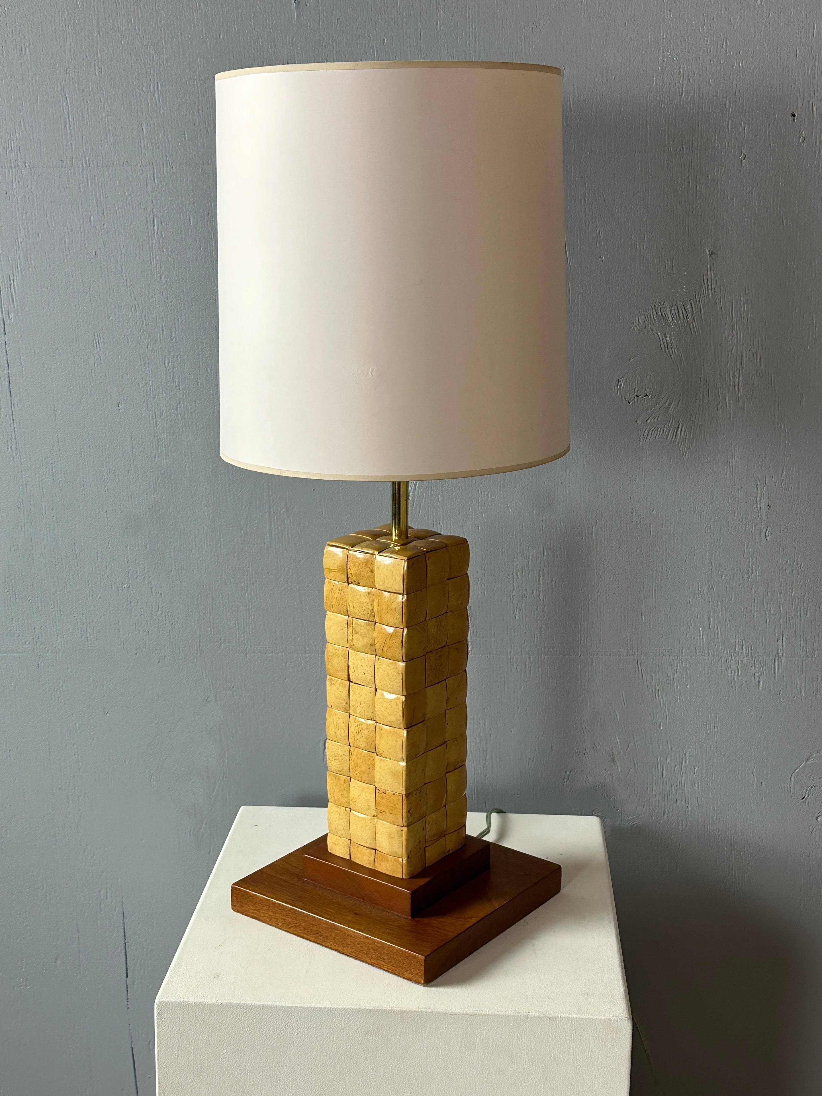 Visionary Paul Laszlo designed this mid-century table lamp for Brown Saltman during the 1950s in the United States.  It has a wood body adorned with Laszlo's chest pattern, reminiscent of his famed 