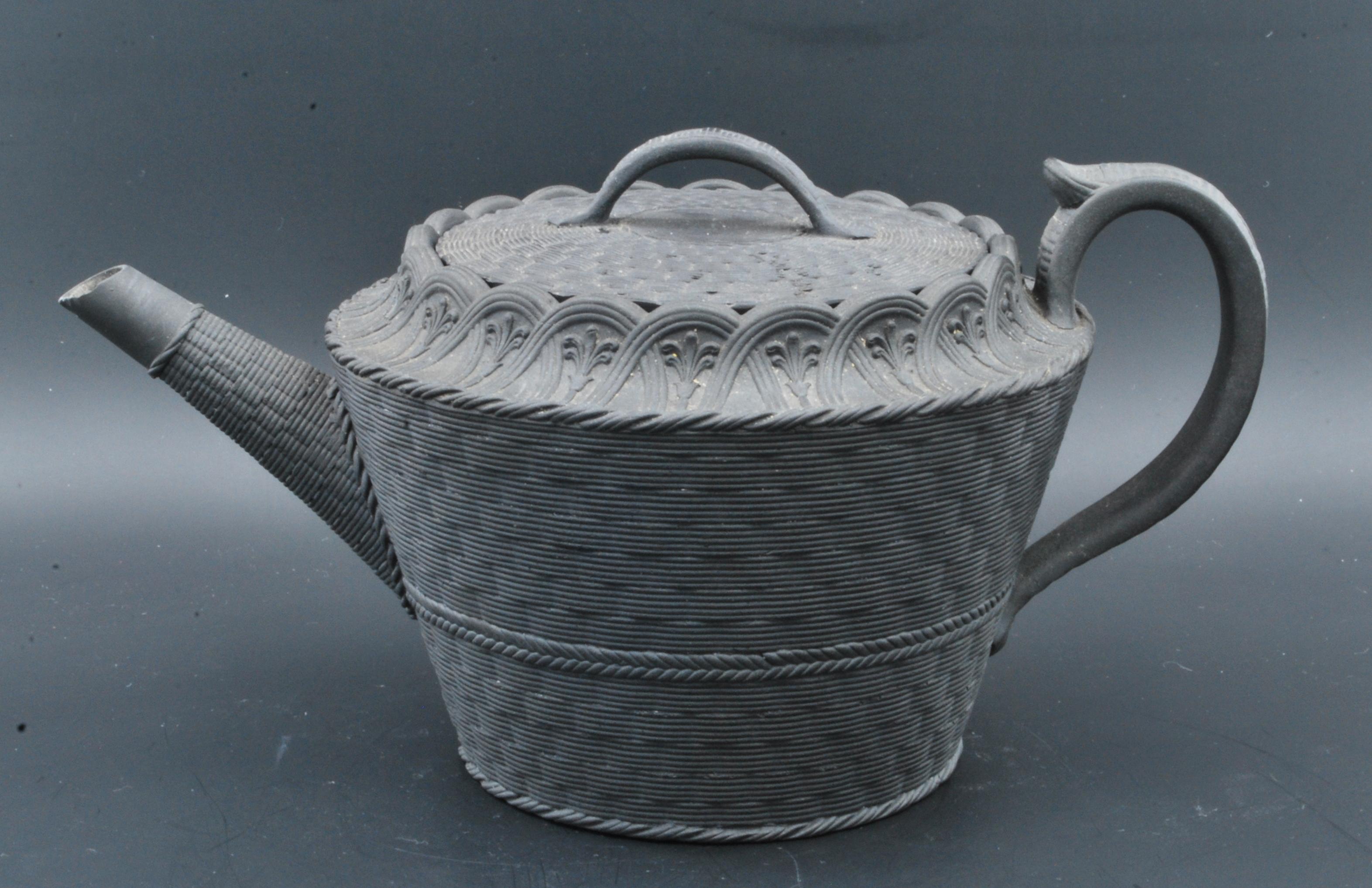 A most attractive and unusual teapot in black basalt, moulded with basket-weave decoration and interlocking arches.

Exhibited: Wedgwood, Master Potter to the Universe, Roche Foundation, 2023.
