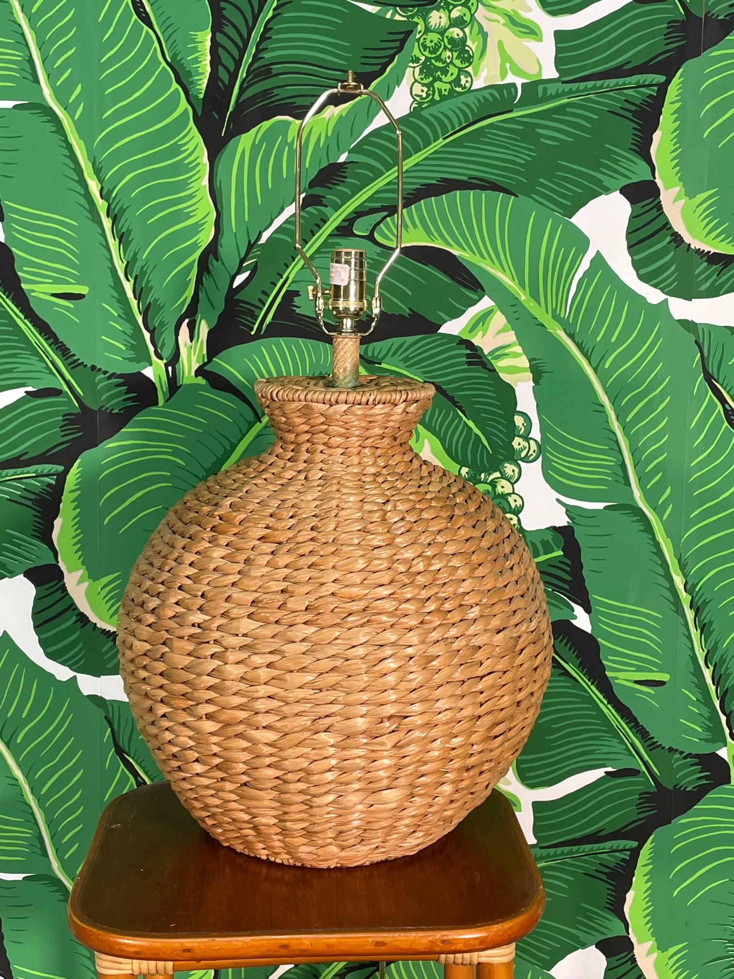 Large ginger jar shaped table lamp features full veneer of woven paper wicker. Brass socket and harp. Measures17