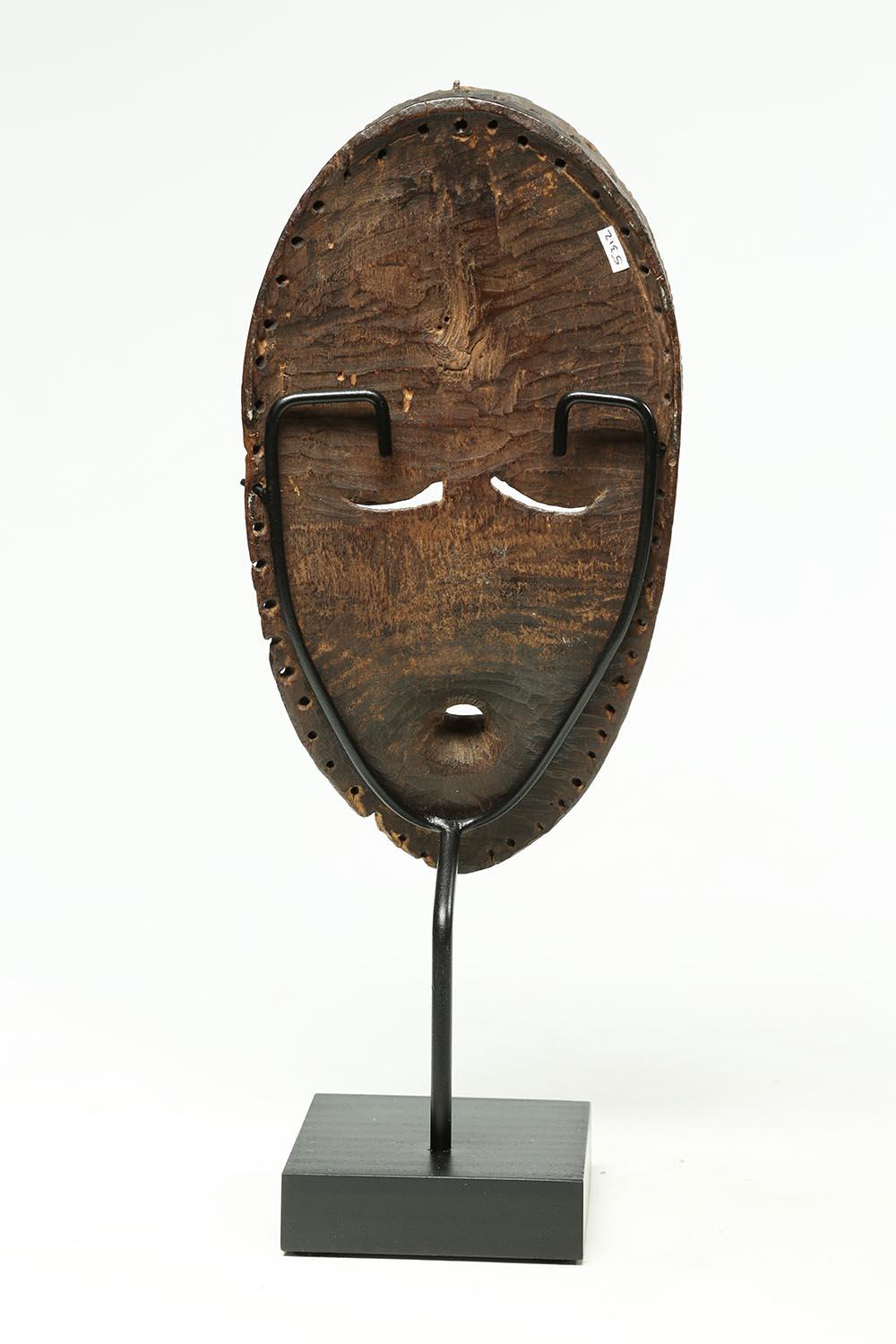 Well-used Bassa dance mask, thin and elegant wood carving with geometric features that would have been attached to a much larger dance costume. The Bassa are from Liberia, West Africa. Finely carved with good evidence of wear from use on the back.