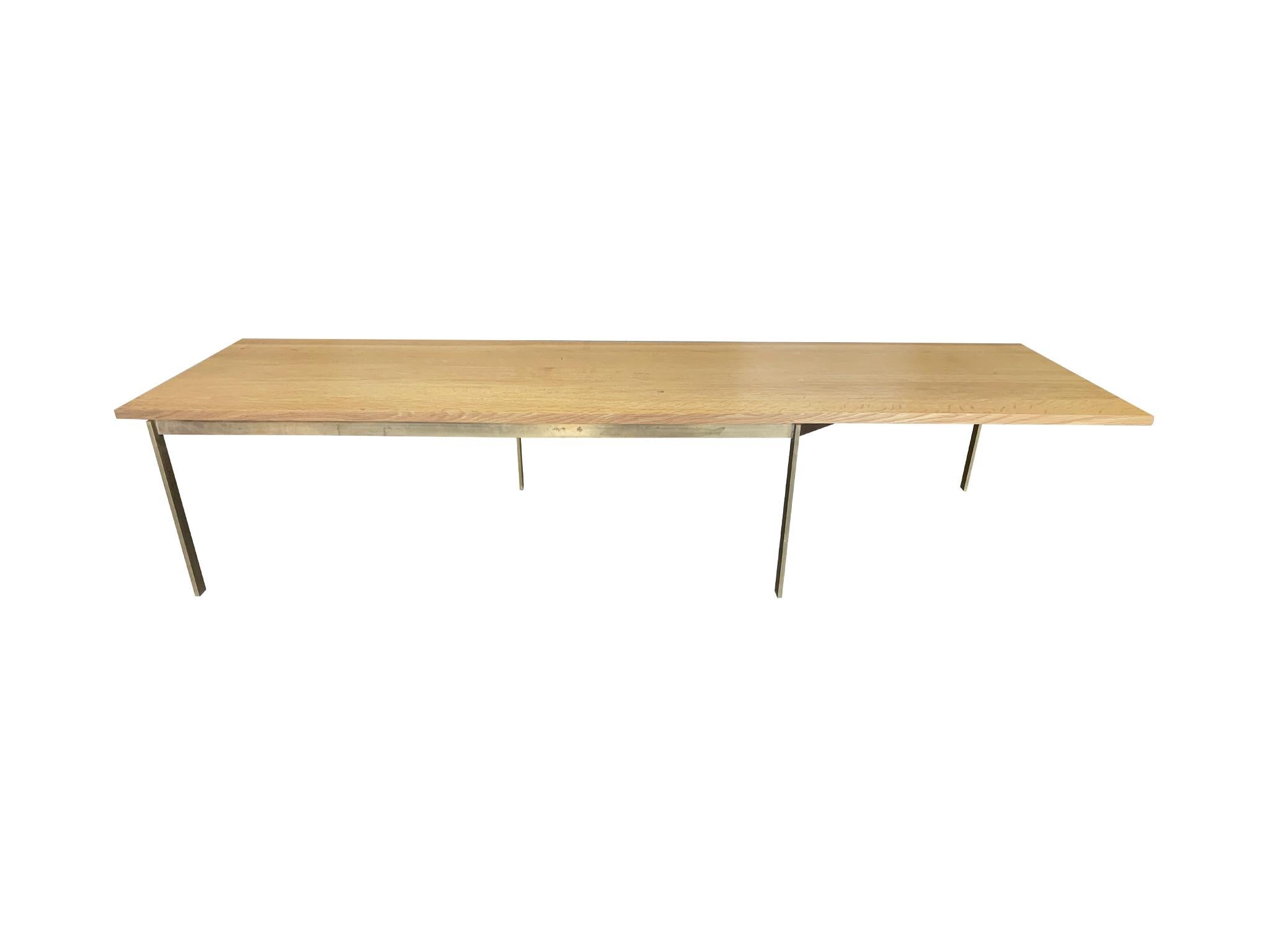 Bespoke coffee table designed by BassamFellows as part of their Plank Occasional Table Collection. It's comprised of an oak top and brass base. The base has a dynamic structure that gives the top the appearance of suspension.

Dimensions:
78 in.