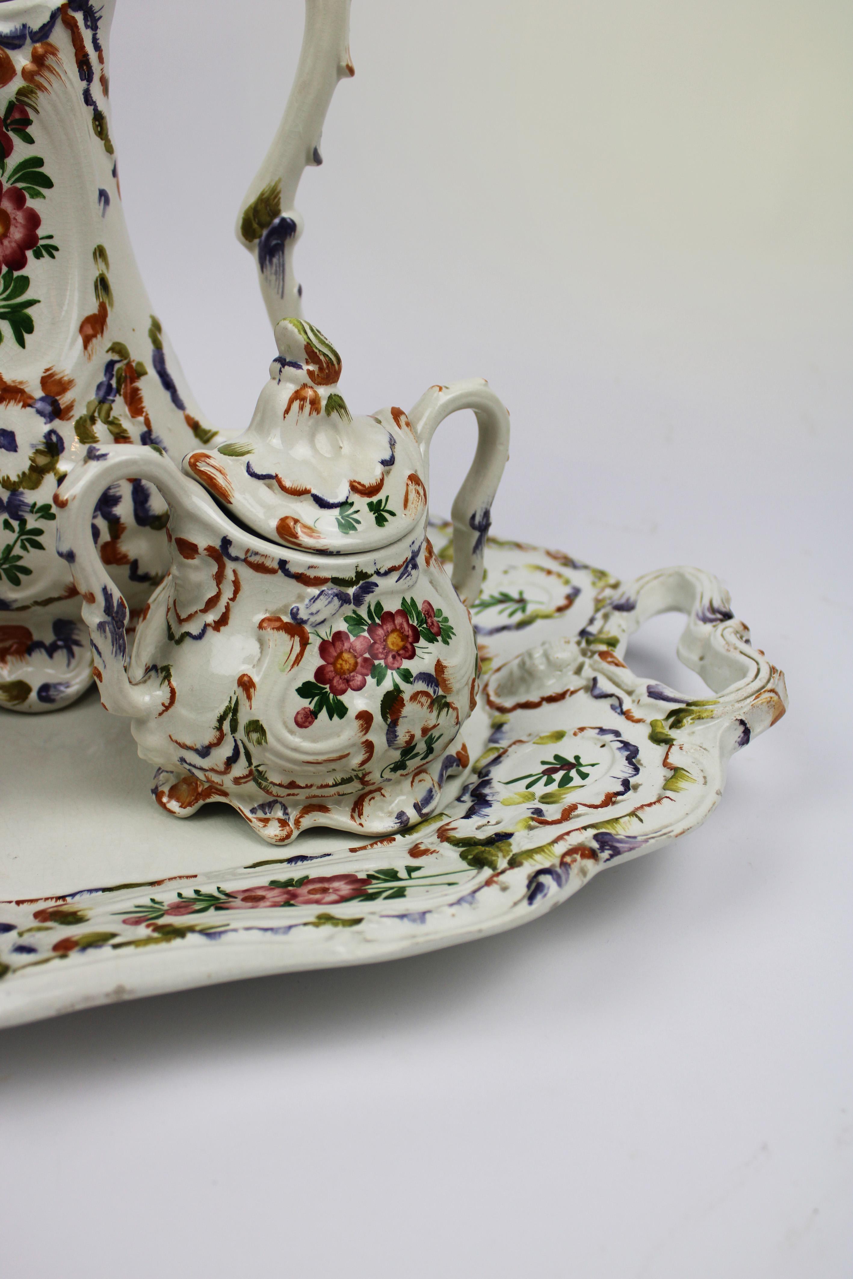 Introducing a charming Bassano Tea & Coffee Set from the 1960s, showcasing the exquisite artistry of Italian ceramics. This delightful set features a beautiful hand-painted floral pattern, capturing the vibrant and intricate details characteristic