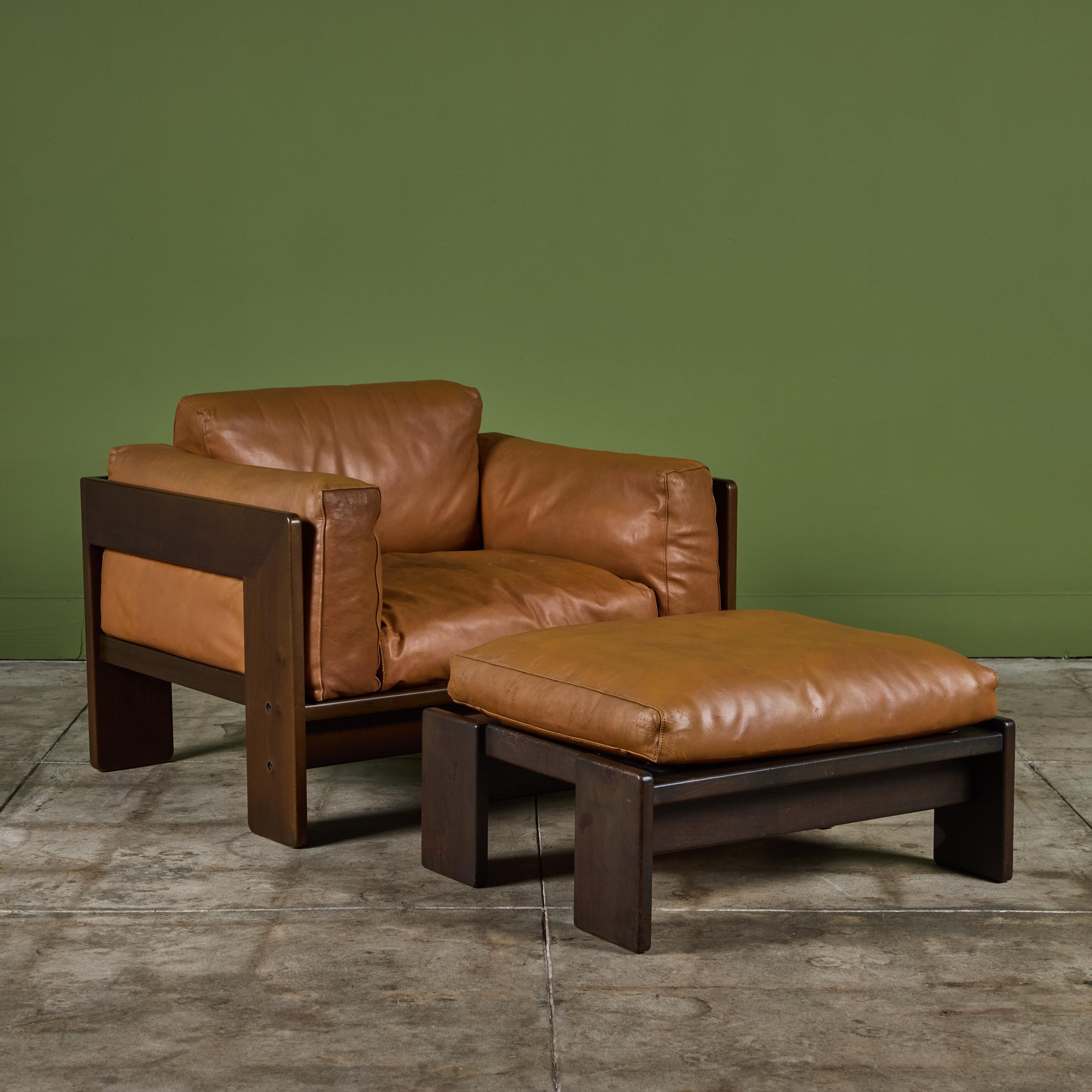 Leather lounge chair and ottoman by Tobia Scarpa for Gavina, c.1970s, Italy. The plush lounge chair features the original tan leather upholstered cushions encased in an angular wood frame.

Dimensions
chair: 36