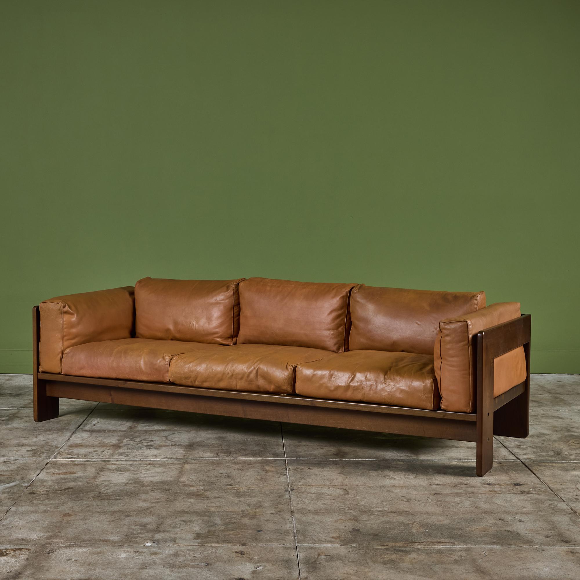 Leather sofa by Tobia Scarpa for Gavina, c.1970s, Italy. The three seater plush sofa features the original leather upholstered cushions encased in an angular wood frame.

Dimensions
83